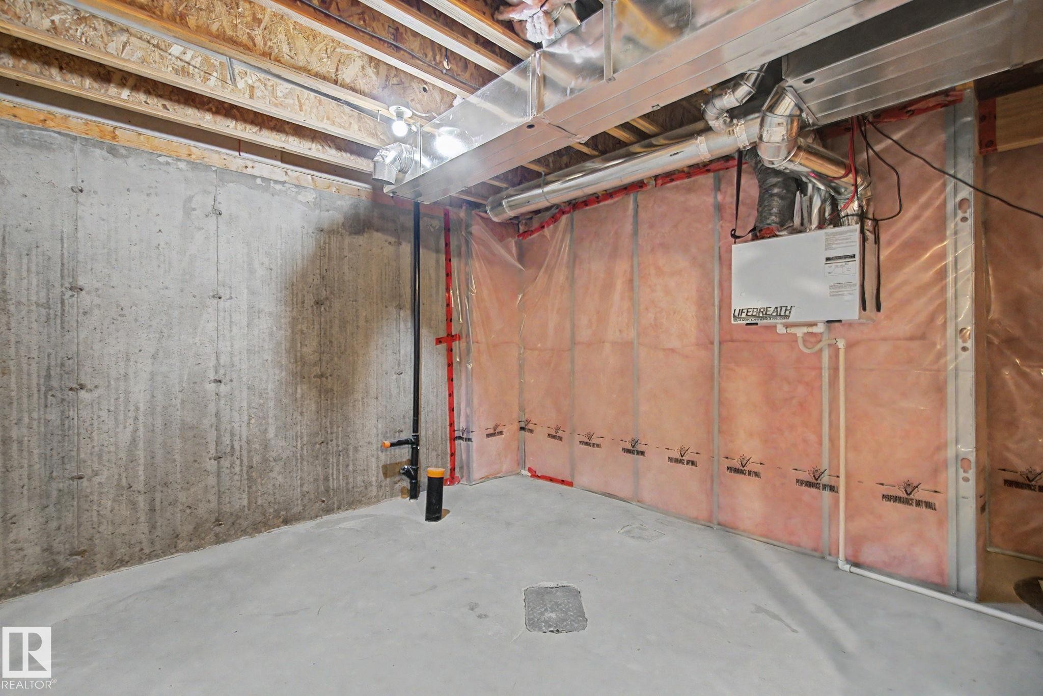Unfinished lower level with concrete slab flooring and exposed concrete foundation walls - 315 Watt Boulevard Sw, Edmonton, AB - Indoor Photo Showing Basement