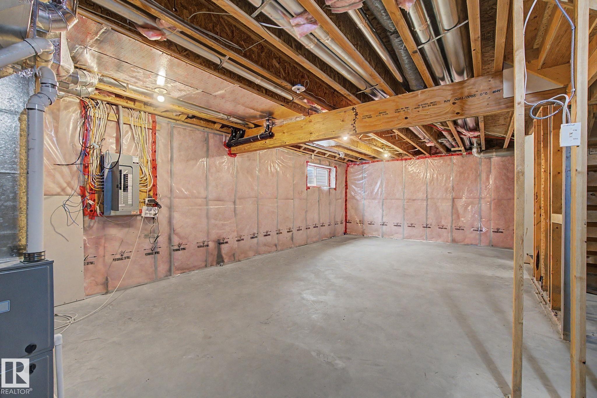 Unfinished basement featuring exposed wood joists, concrete flooring, and a small window for natural light - 315 Watt Boulevard Sw, Edmonton, AB - Indoor Photo Showing Basement