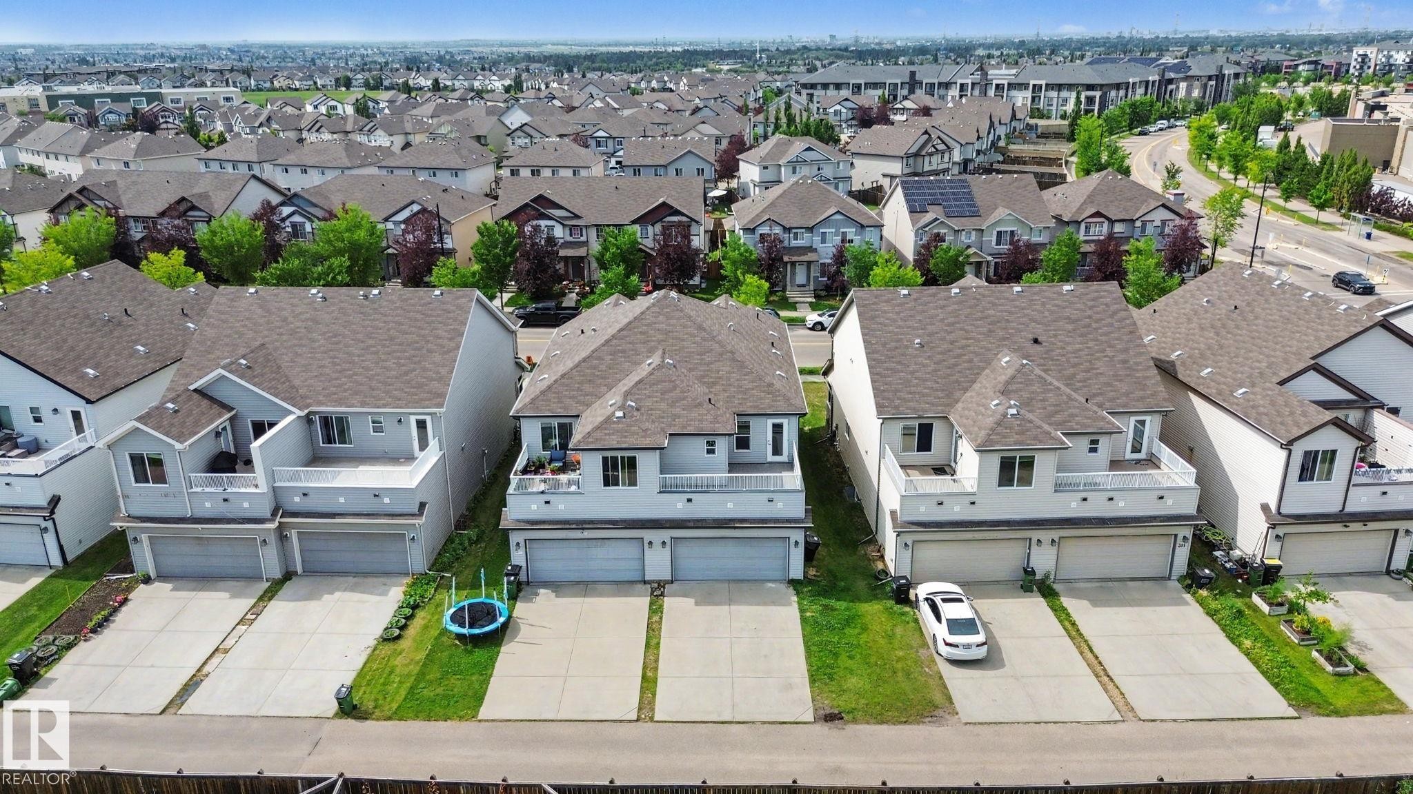 Residential property featuring a light grey exterior, private balcony with white railings, and a two-car garage - 315 Watt Boulevard Sw, Edmonton, AB - Outdoor With Facade