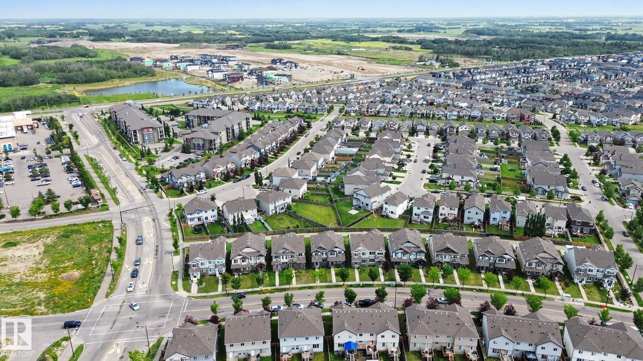 Modern suburban development featuring residential homes with diverse architectural styles, visible streets, and green spaces - 315 Watt Boulevard Sw, Edmonton, AB - Outdoor With View