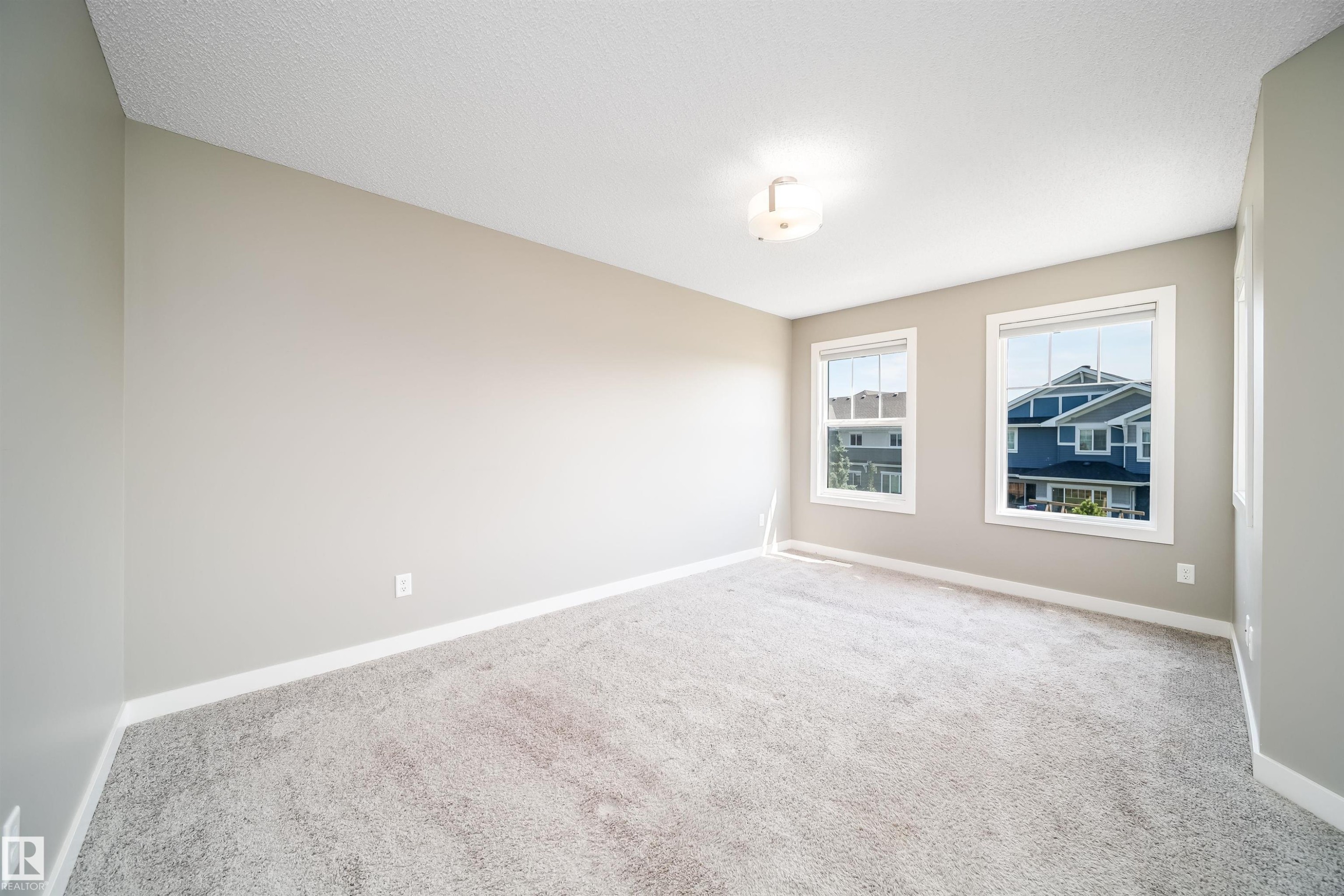 Neutral-toned walls complement plush grey carpeting - 114 James Crescent, St. Albert, AB - Indoor Photo Showing Other Room