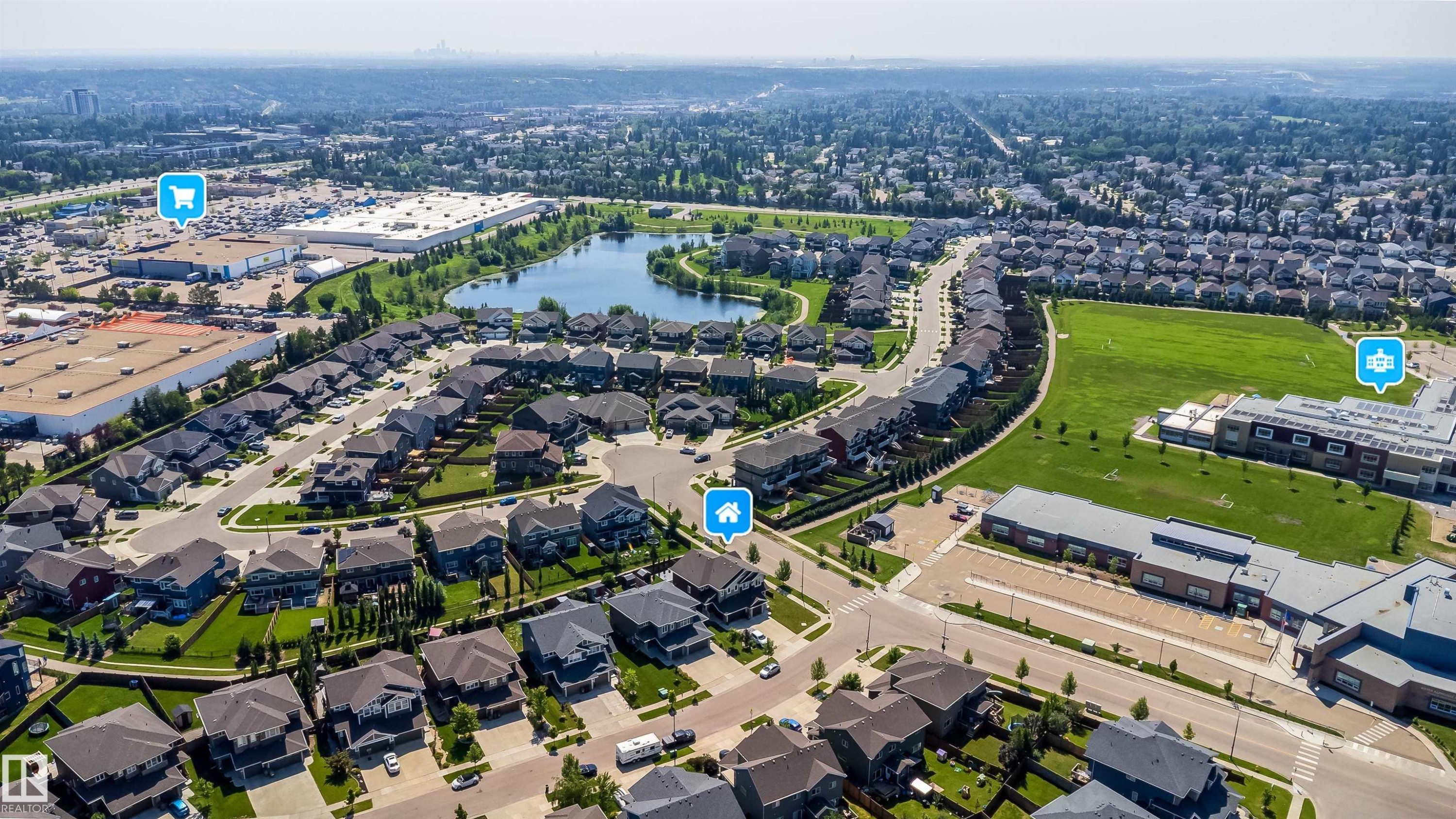Aerial perspective showcasing the residential area, commercial establishments, and a natural body of water - 114 James Crescent, St. Albert, AB - Outdoor With View