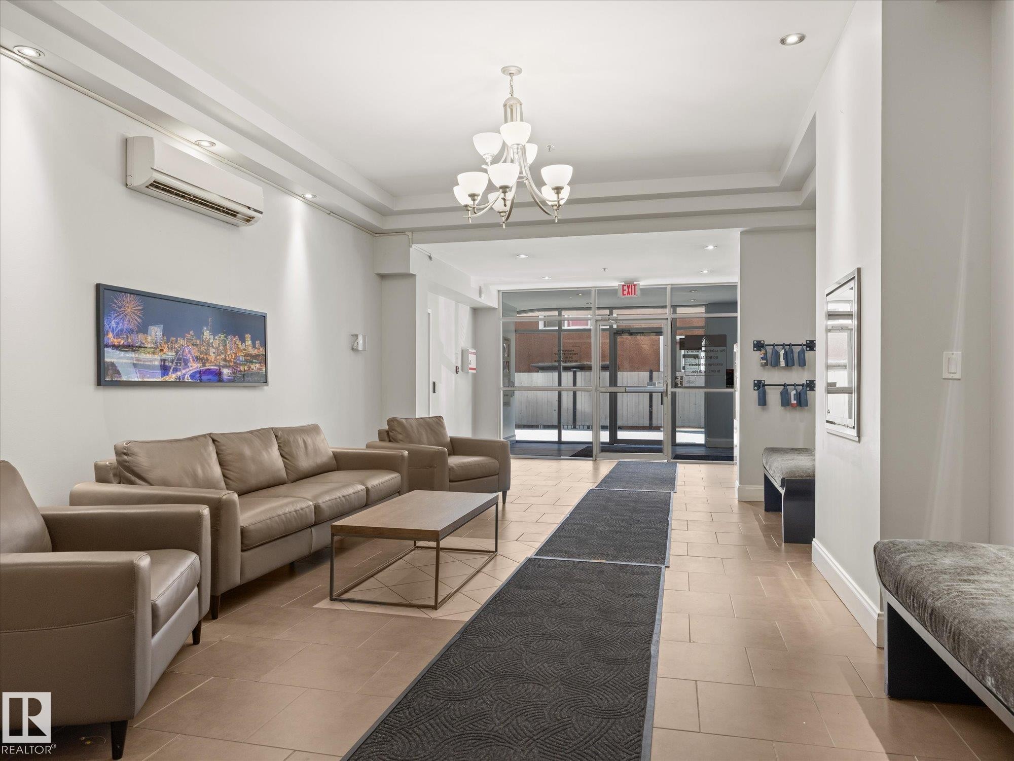Spacious common area featuring light-toned tile flooring and recessed lighting - #707 9819 104 St Nw, Edmonton, AB