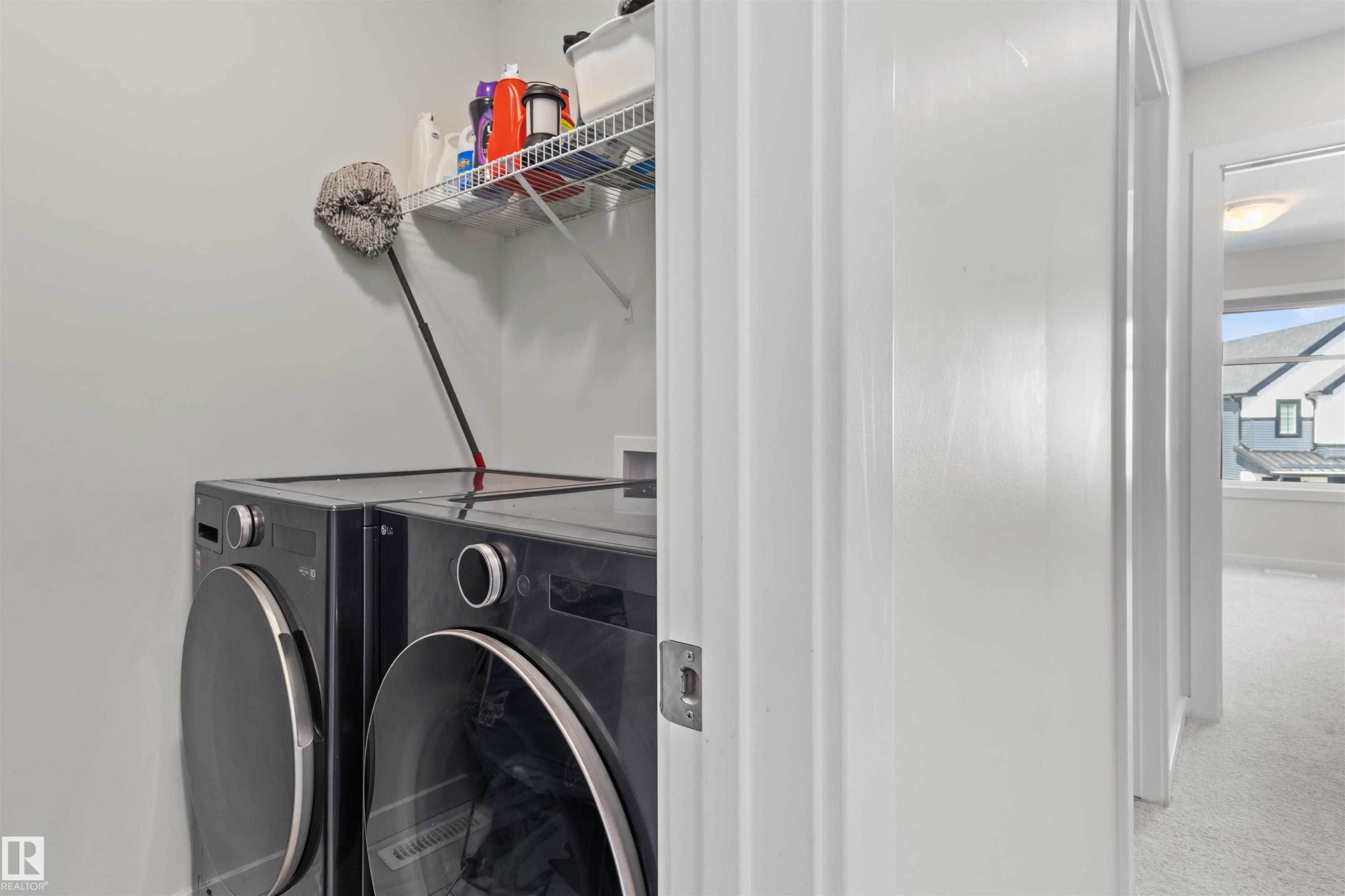 Dedicated laundry area featuring a wire shelf and light gray walls - 1471 Plum Circle Sw, Edmonton, AB - Indoor Photo Showing Laundry Room