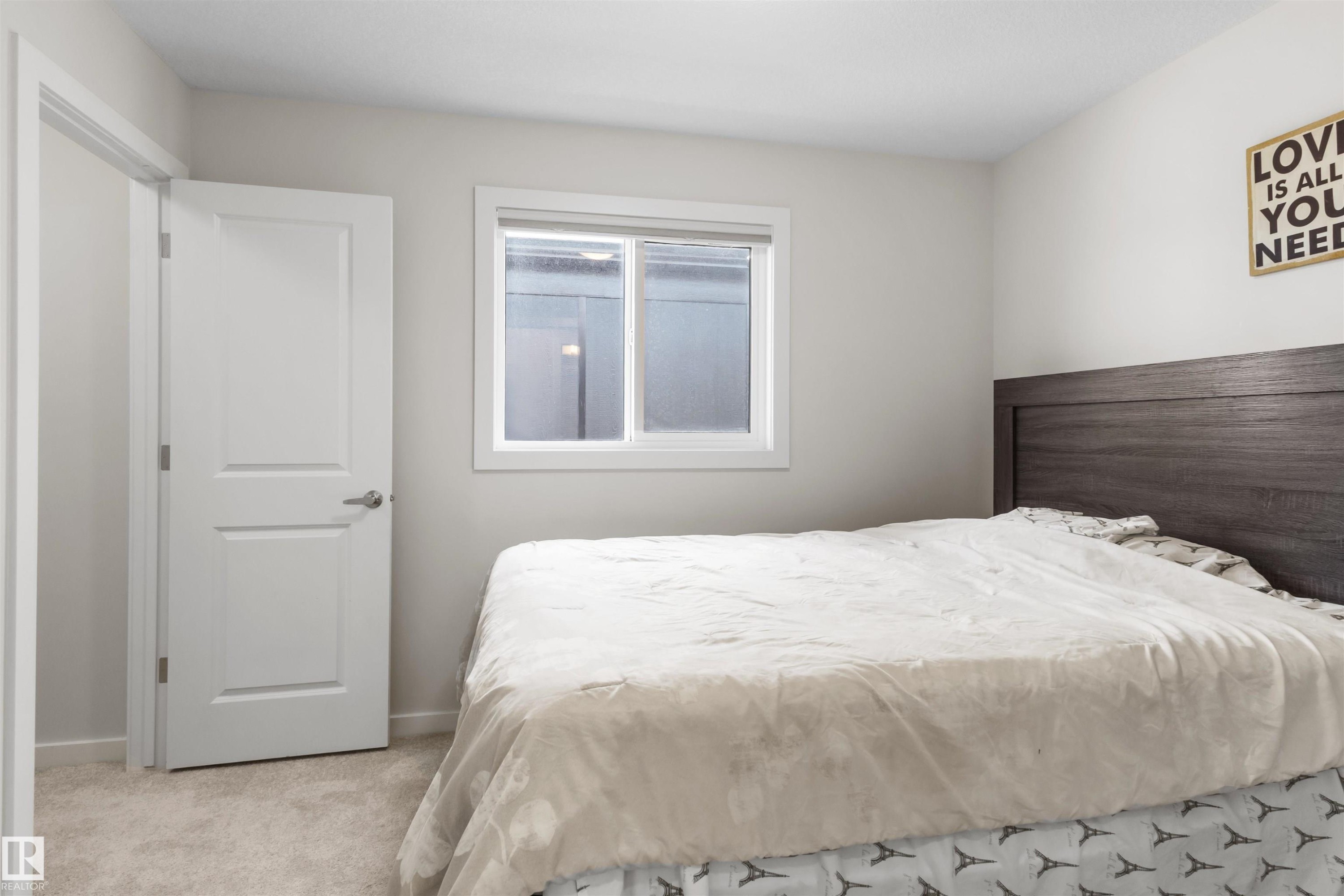 Neutral-toned walls complement light-colored carpeting - 1471 Plum Circle Sw, Edmonton, AB - Indoor Photo Showing Bedroom