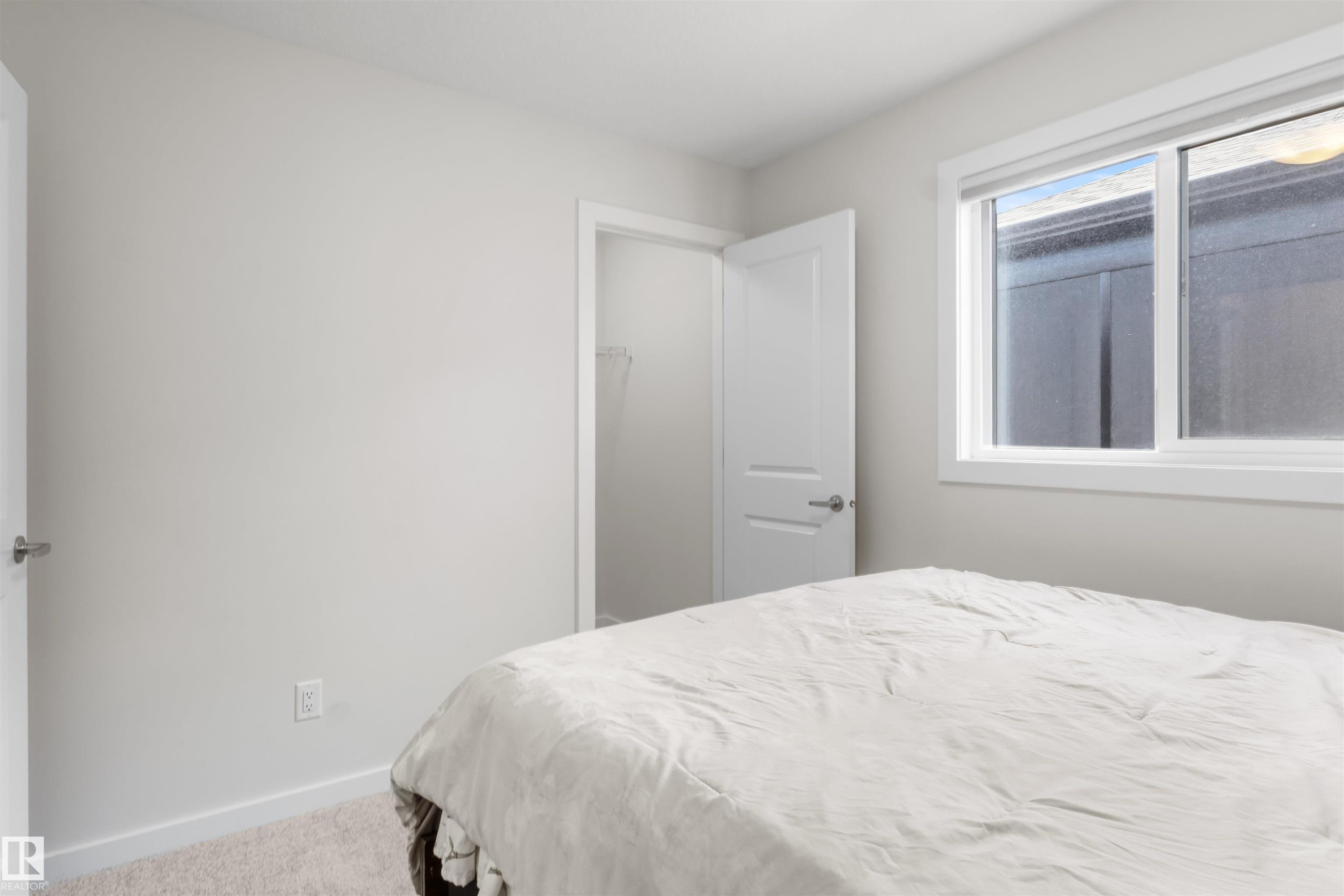 Room featuring light gray wall paint, white trim, and neutral carpet flooring - 1471 Plum Circle Sw, Edmonton, AB - Indoor Photo Showing Bedroom