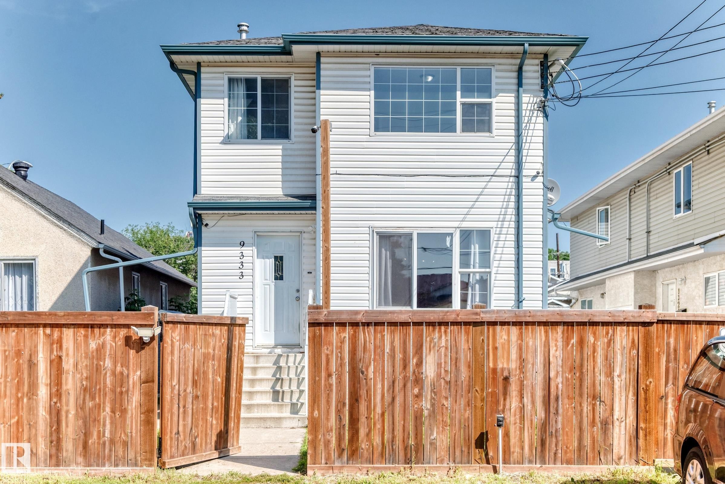 Two-story residence featuring white siding and a dark roofline - 9333 103A Avenue Nw, Edmonton, AB - Outdoor With Exterior