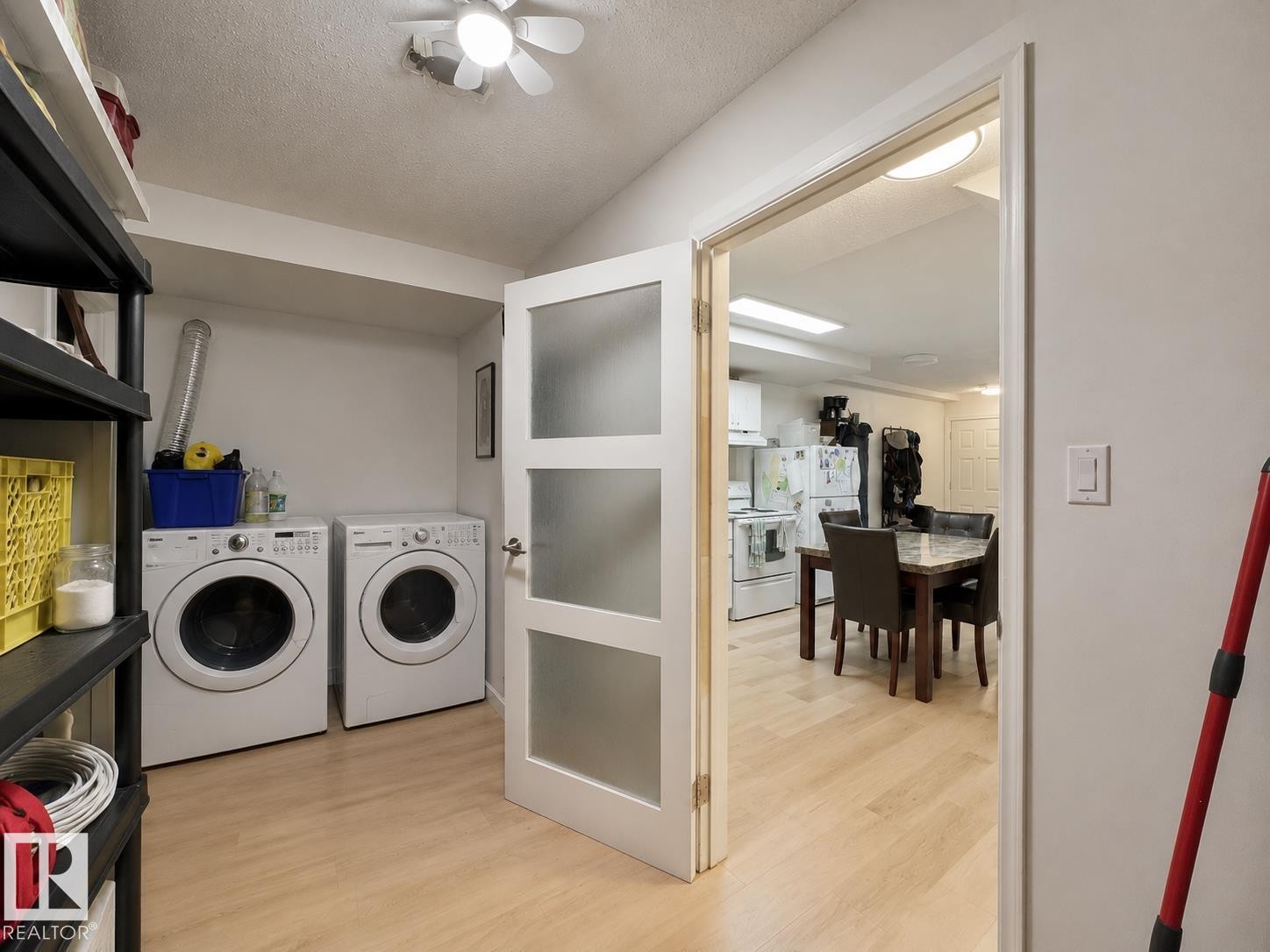 Dedicated laundry area with light wood-finish flooring, featuring a pair of front-loading appliances - #29 13580 38 St Nw, Edmonton, AB - Indoor Photo Showing Laundry Room
