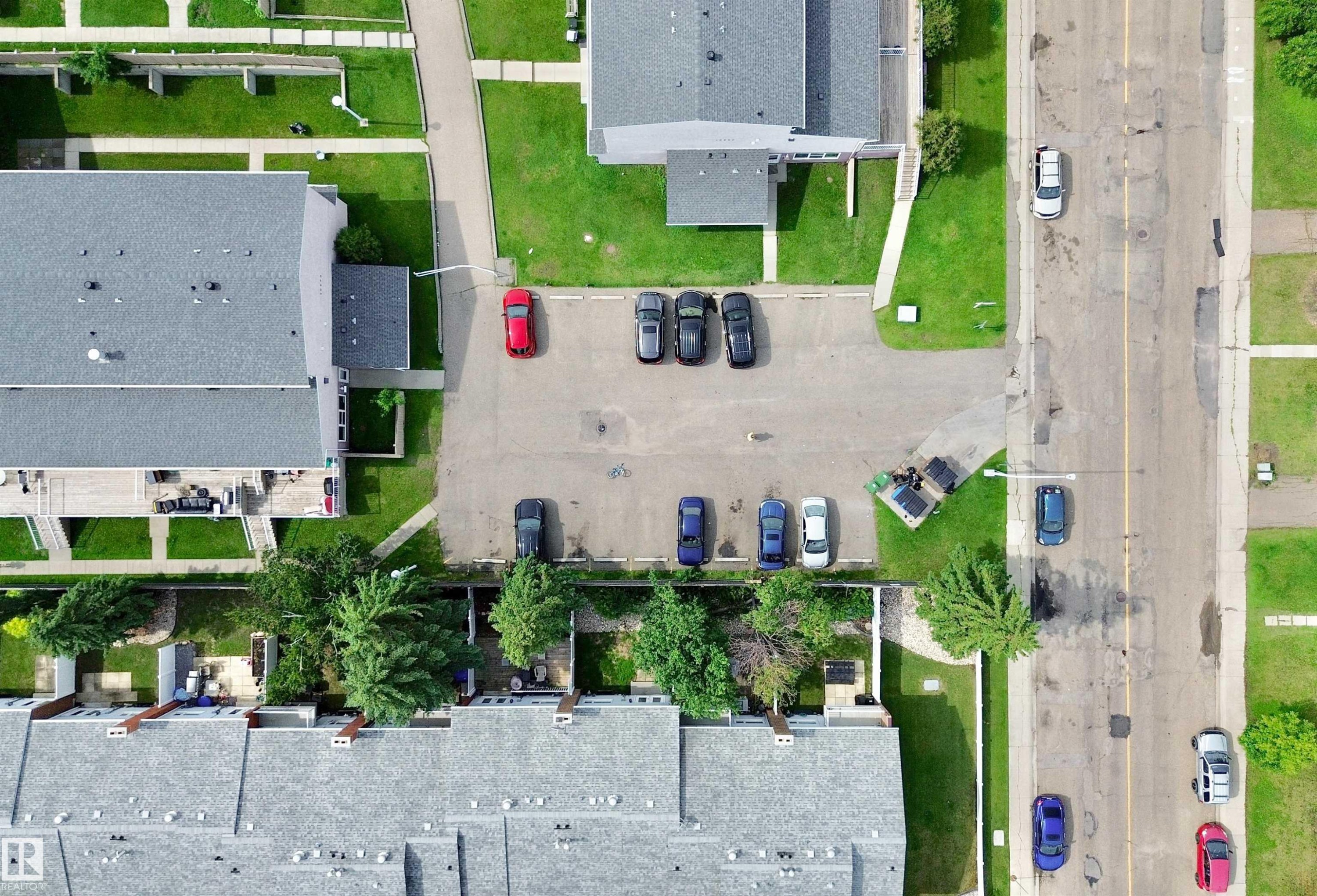 Aerial perspective showcasing multiple residential buildings with gray shingle roofing - #29 13580 38 St Nw, Edmonton, AB -