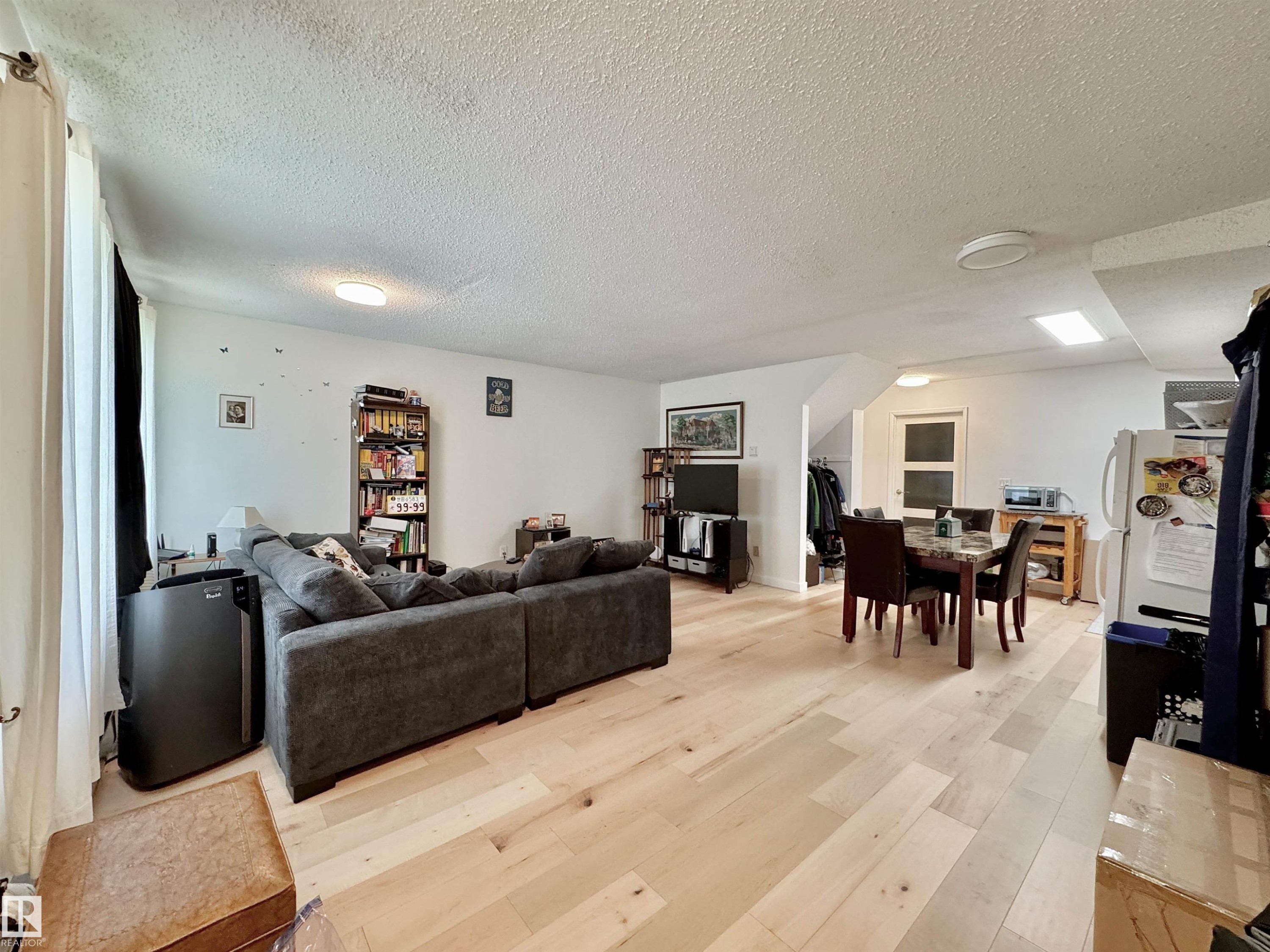 Open-concept living space featuring light wood-finish flooring, white walls, and recessed lighting - #29 13580 38 St Nw, Edmonton, AB - Indoor Photo Showing Other Room