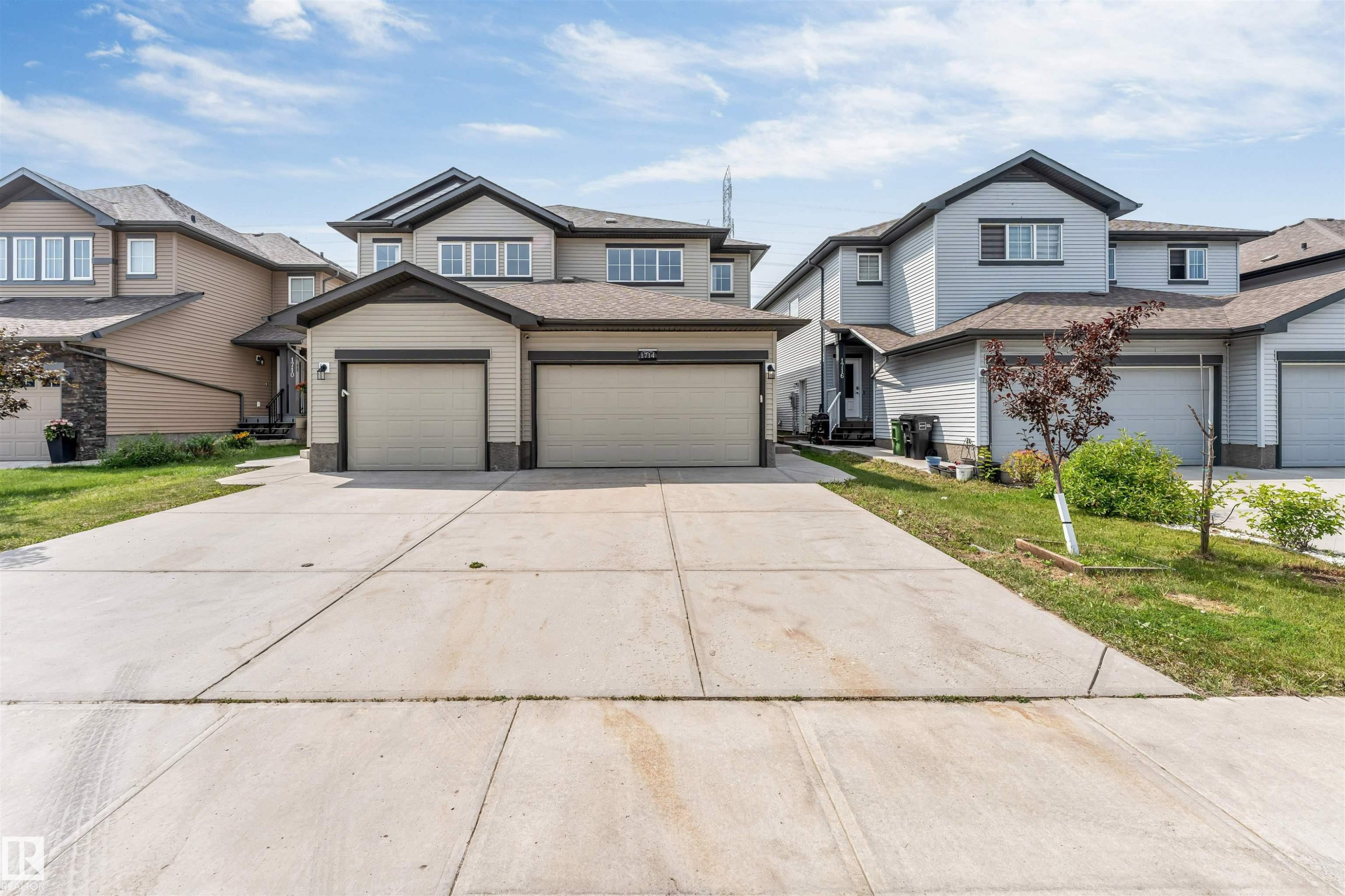 Contemporary two-story exterior featuring a double-car garage and a concrete driveway - 1712 27 St Nw, Edmonton, AB - Outdoor With Facade