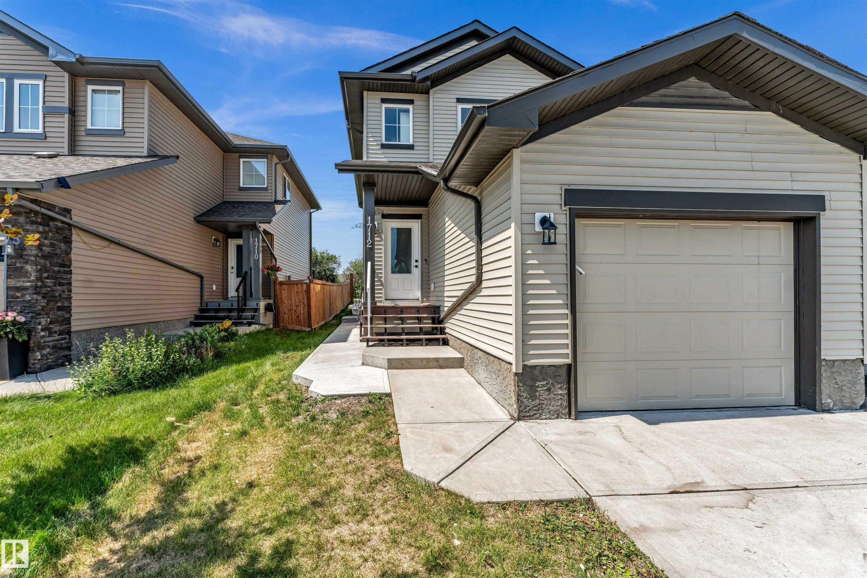 Contemporary exterior with light-toned siding and dark trim accents - 1712 27 St Nw, Edmonton, AB - Outdoor With Facade