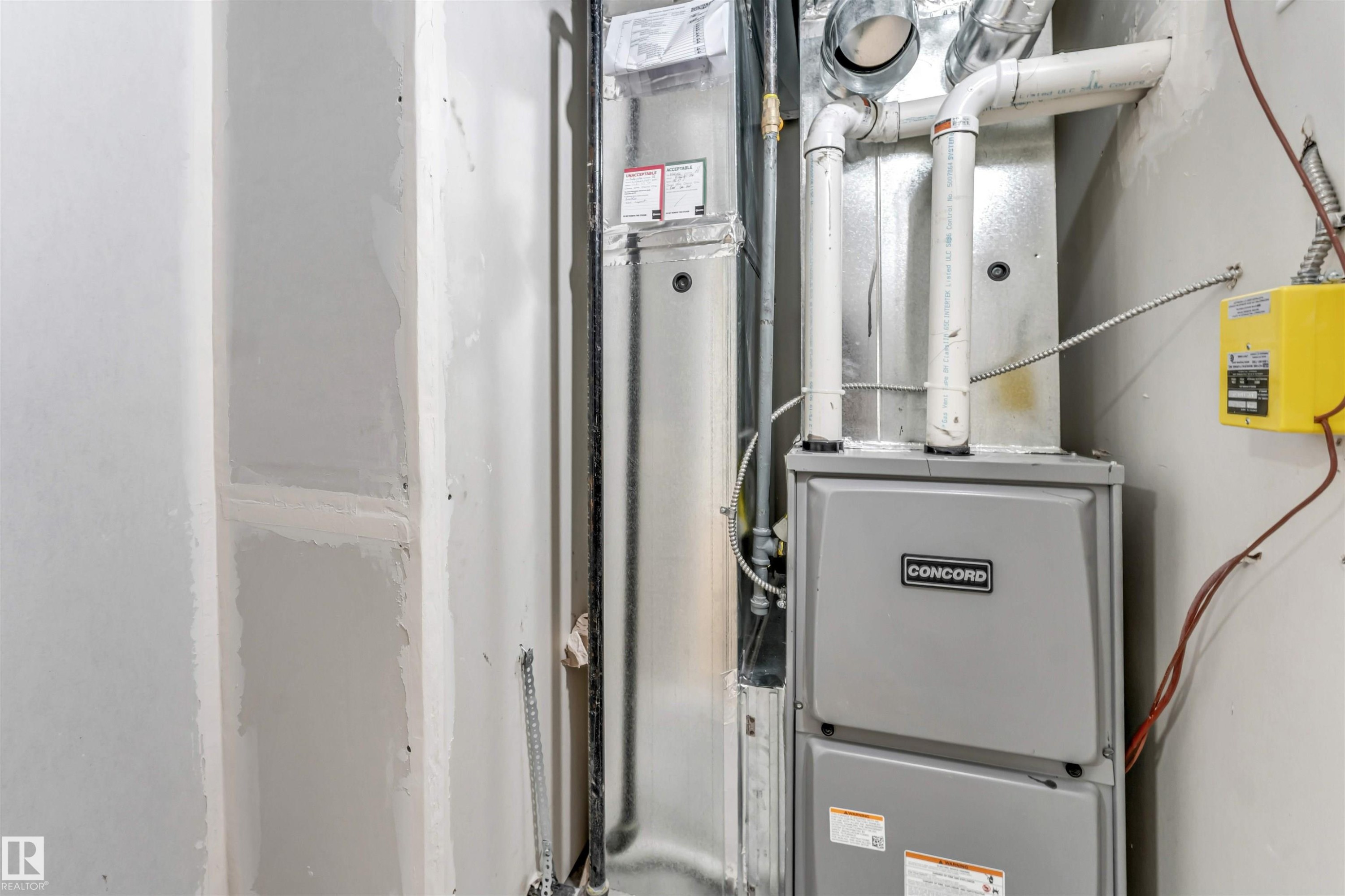 Concord furnace unit with visible ductwork and associated piping - 1712 27 St Nw, Edmonton, AB - Indoor Photo Showing Basement