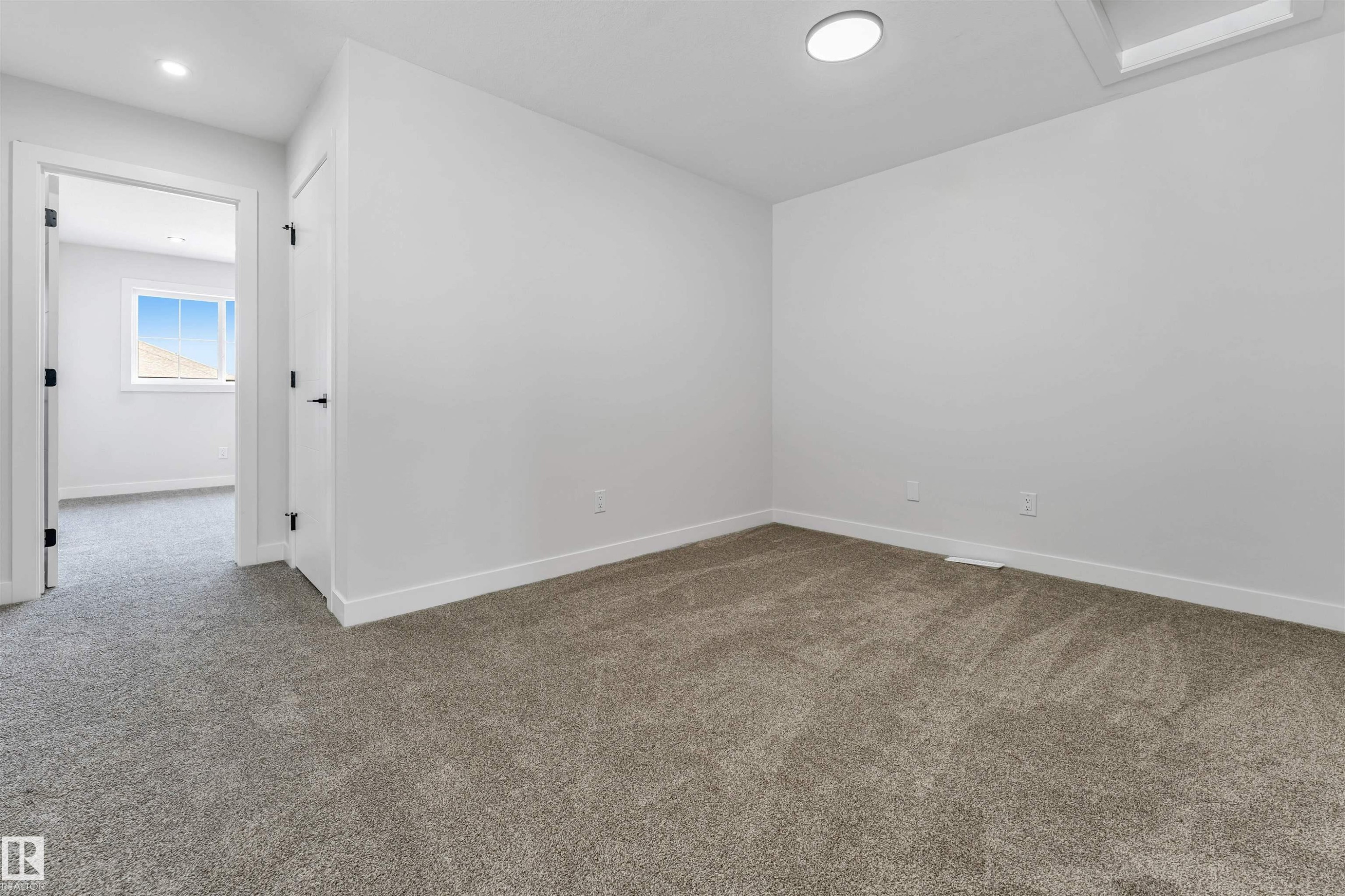 Carpeted room featuring white walls and baseboards - 1714 27 St. Nw, Edmonton, AB - Indoor Photo Showing Other Room
