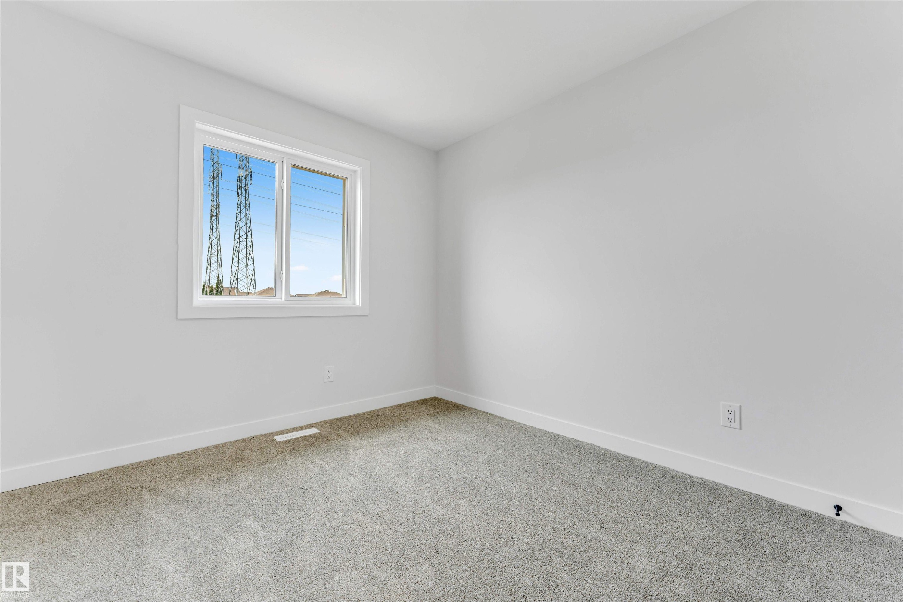 Clean interior room featuring light gray carpeting and white baseboards - 1714 27 St. Nw, Edmonton, AB - Indoor Photo Showing Other Room