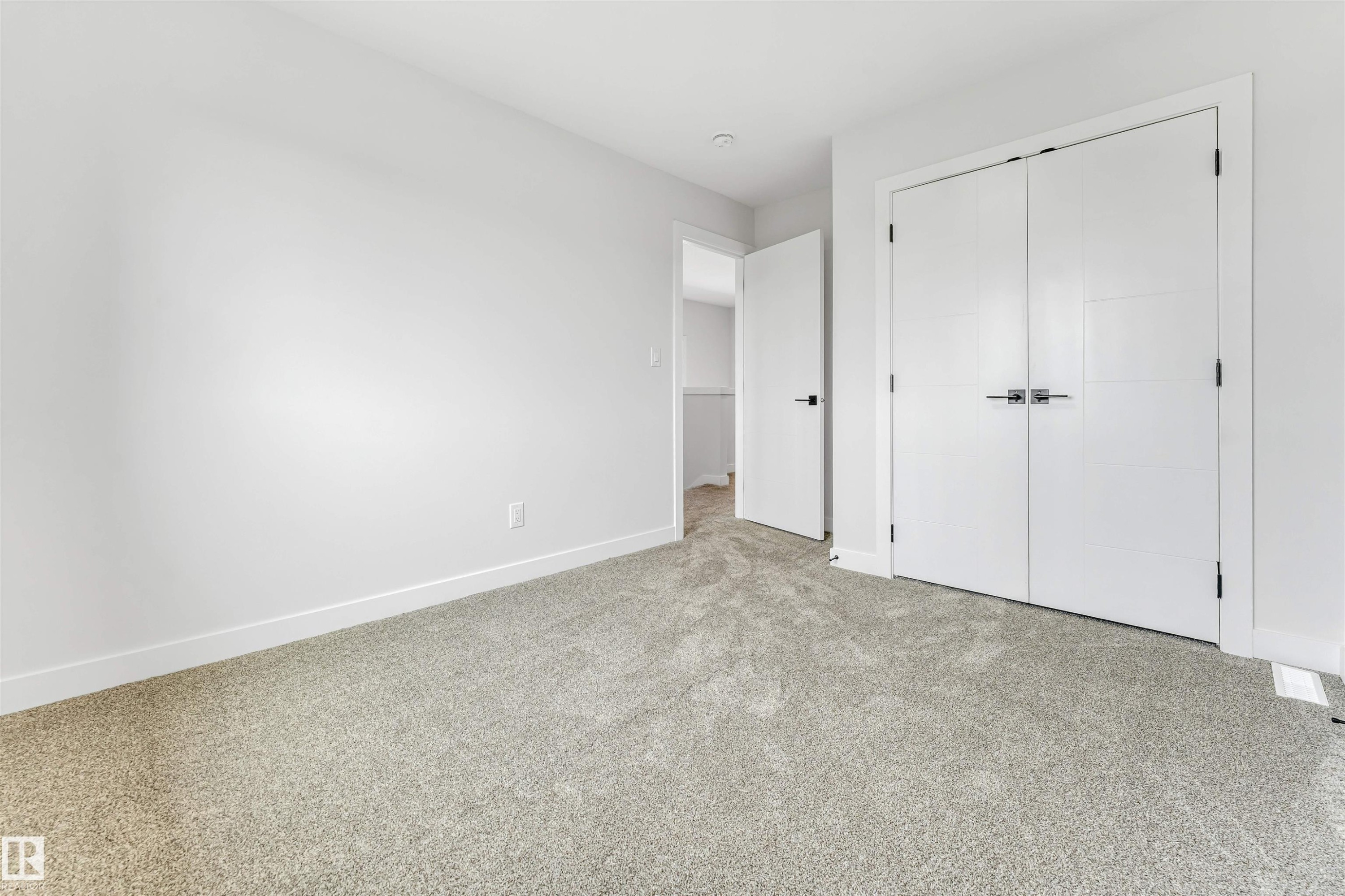 White walls complementing light gray carpet flooring - 1714 27 St. Nw, Edmonton, AB - Indoor Photo Showing Other Room