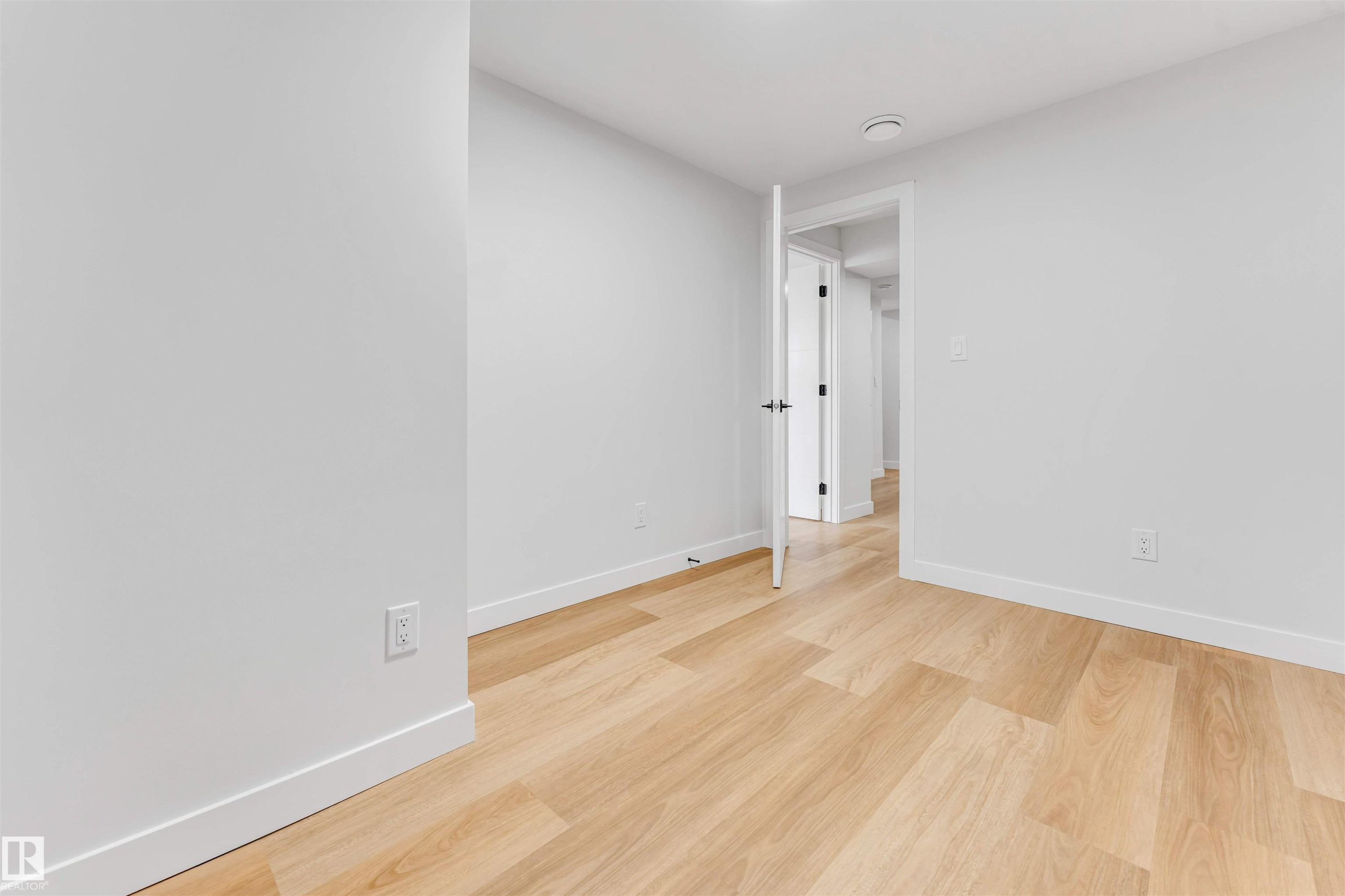 Room featuring light wood-finish flooring, white walls, and white baseboards - 1714 27 St. Nw, Edmonton, AB - Indoor Photo Showing Other Room