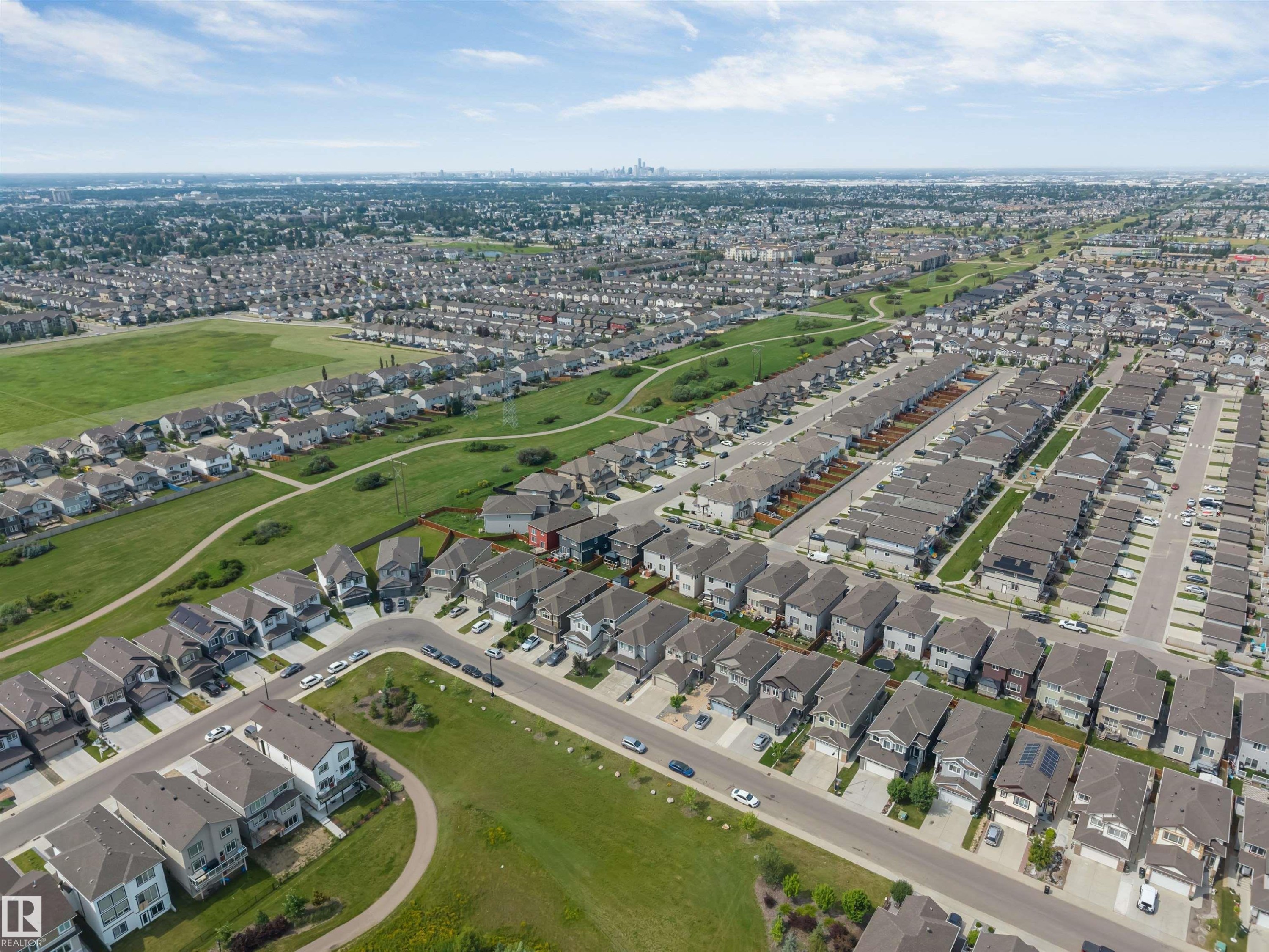 Expansive aerial perspective showcasing a residential development with multiple detached homes featuring varied architectural styles and rooflines - 1714 27 St. Nw, Edmonton, AB - Outdoor With View