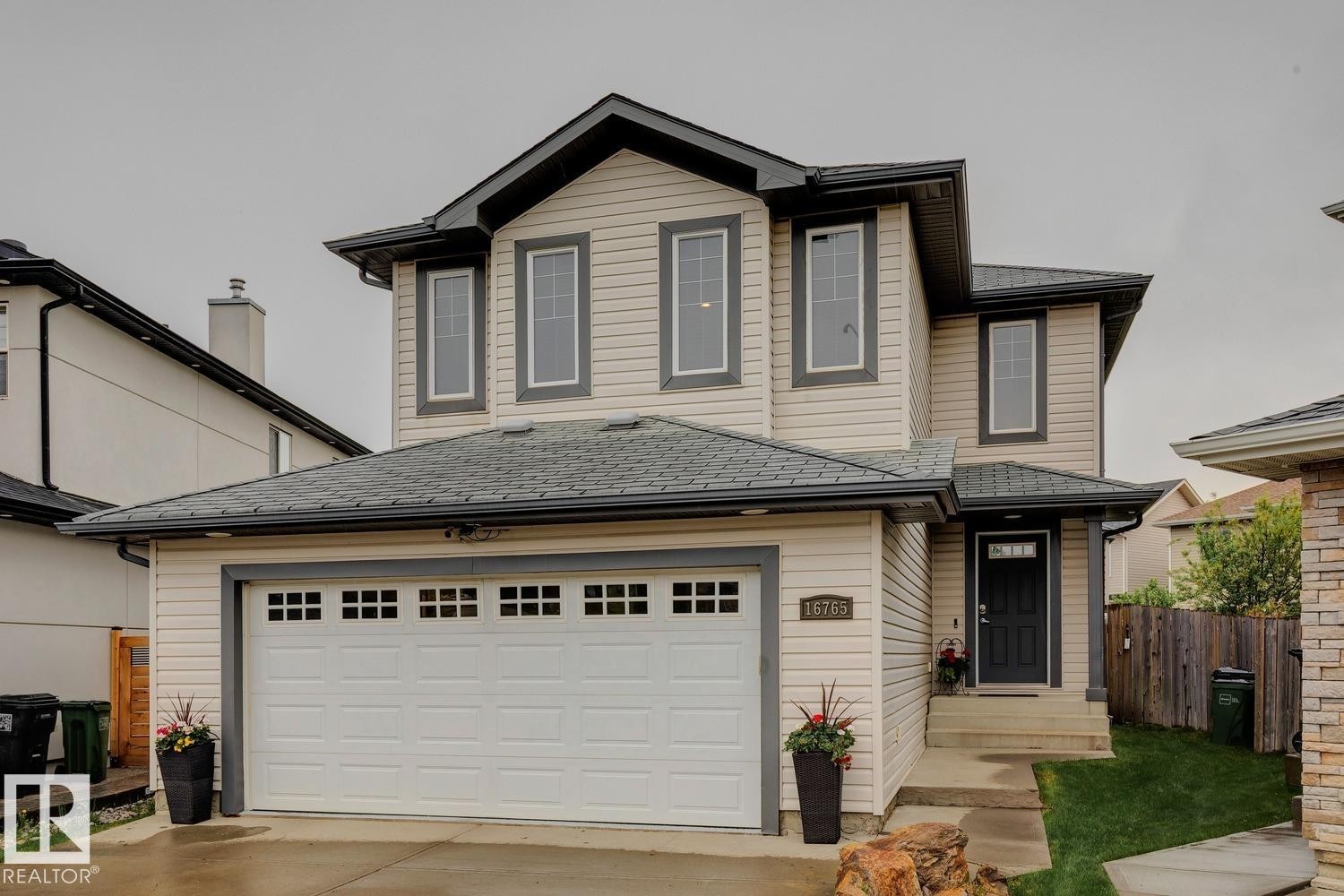 Contemporary two-story residence featuring light-colored siding and dark trim - 16765 119 Street Nw, Edmonton, AB - Outdoor