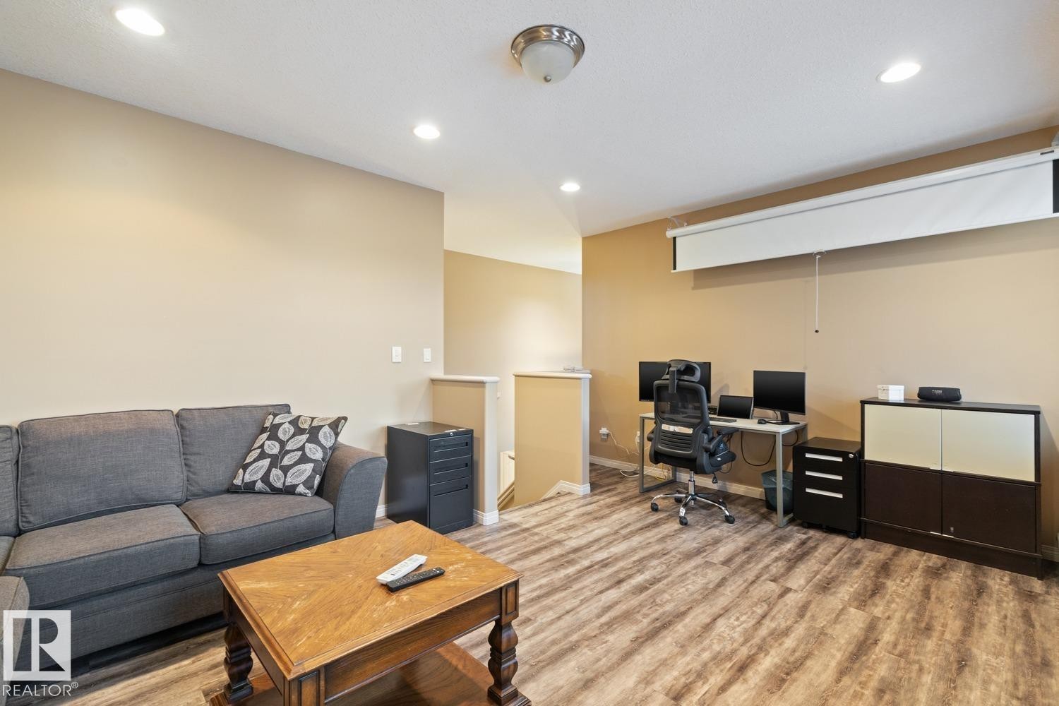 Open-concept room featuring recessed lighting, a ceiling-mounted light fixture, and wood-finish flooring - 16765 119 Street Nw, Edmonton, AB - Indoor