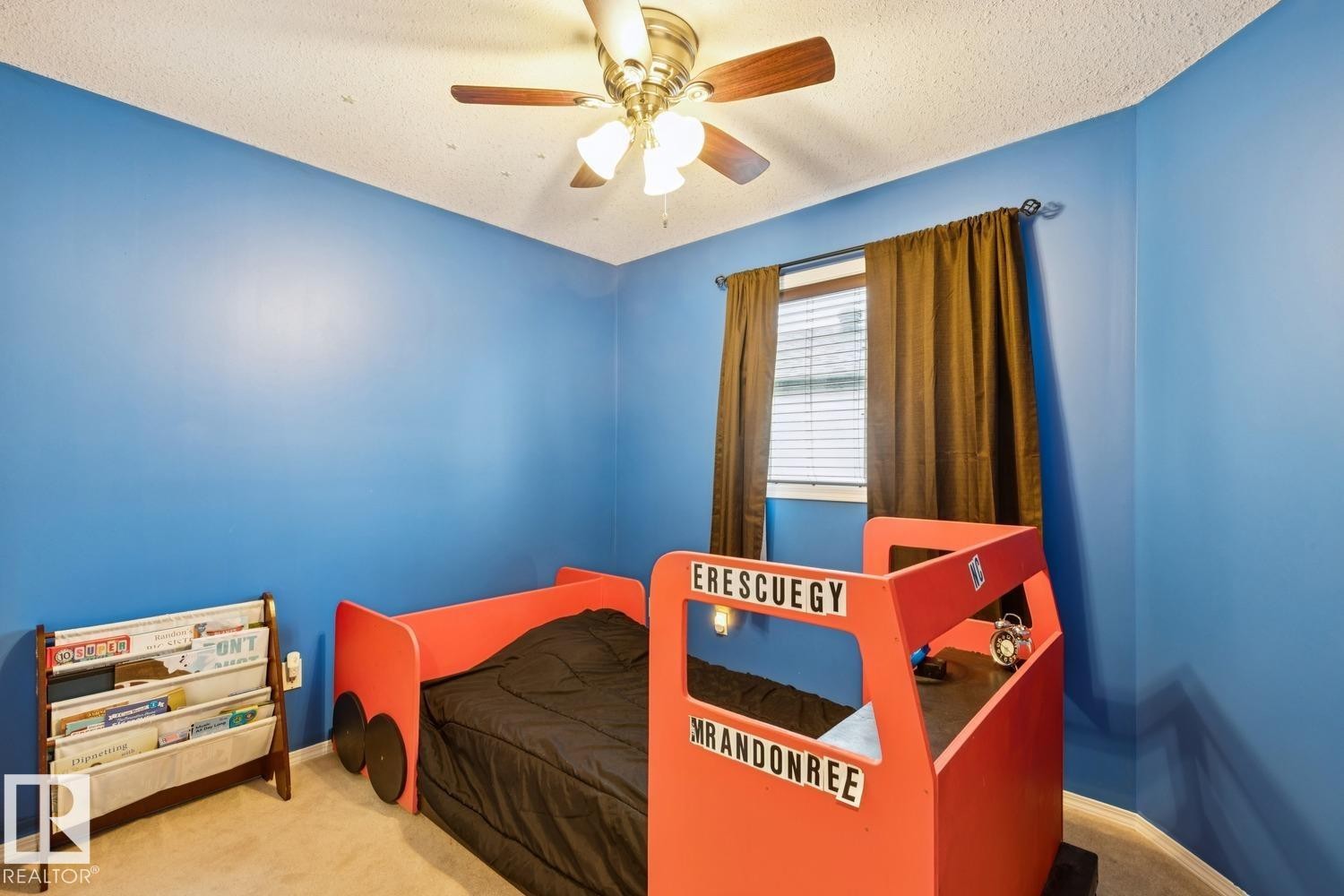 Bedroom featuring a ceiling fan with light fixture, window with blinds and dark-toned curtains, and carpeted flooring - 16765 119 Street Nw, Edmonton, AB - Indoor Photo Showing Bedroom