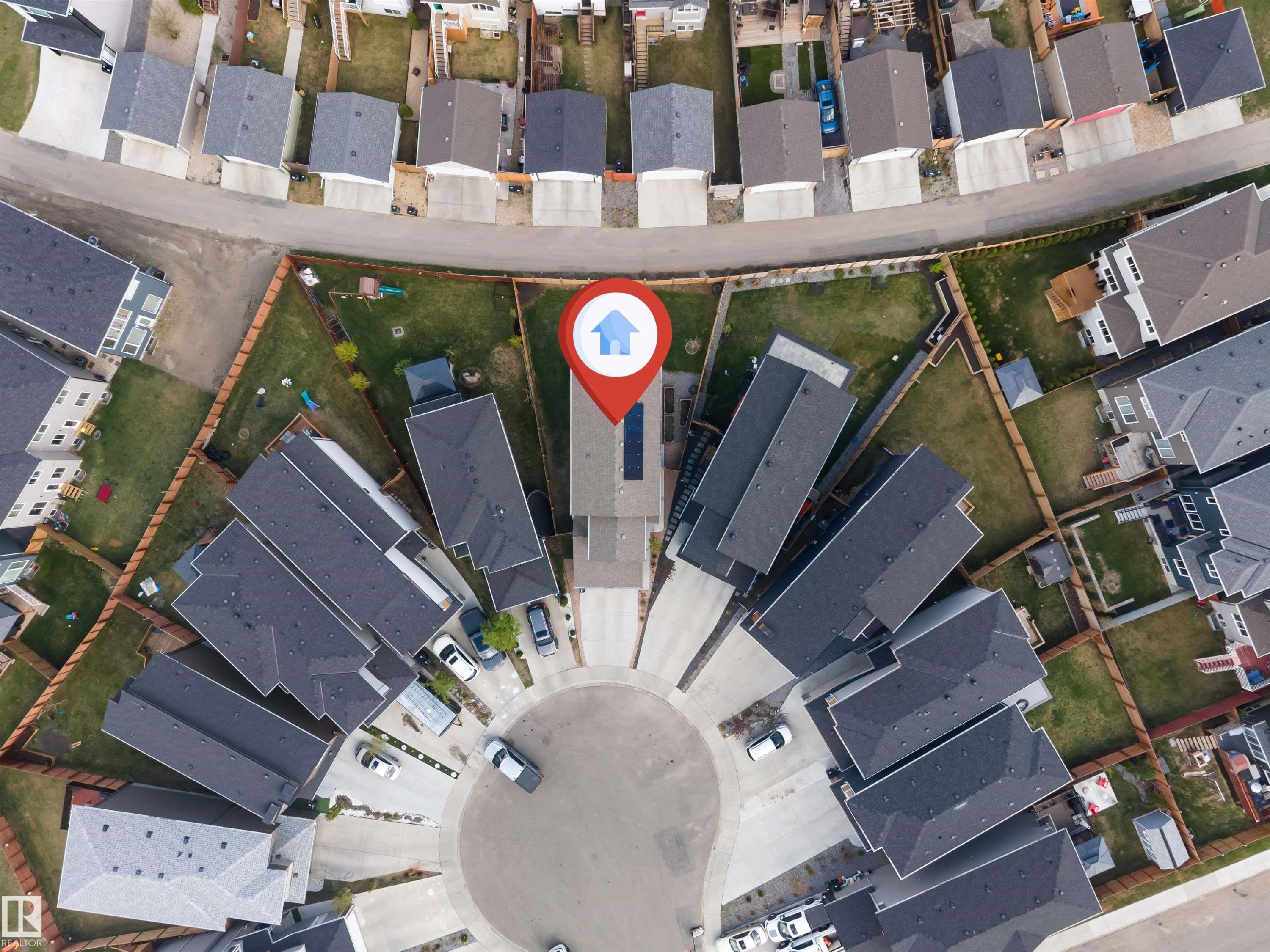 Property situated within a cul-de-sac, featuring multiple residential structures with dark grey roofing - 425 41 Street, Edmonton, AB -