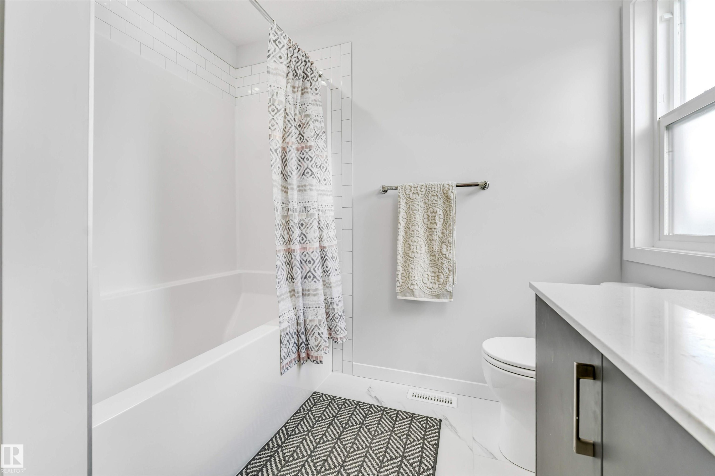 Tub and shower combination featuring subway tile surround - 425 41 Street, Edmonton, AB - Indoor Photo Showing Bathroom