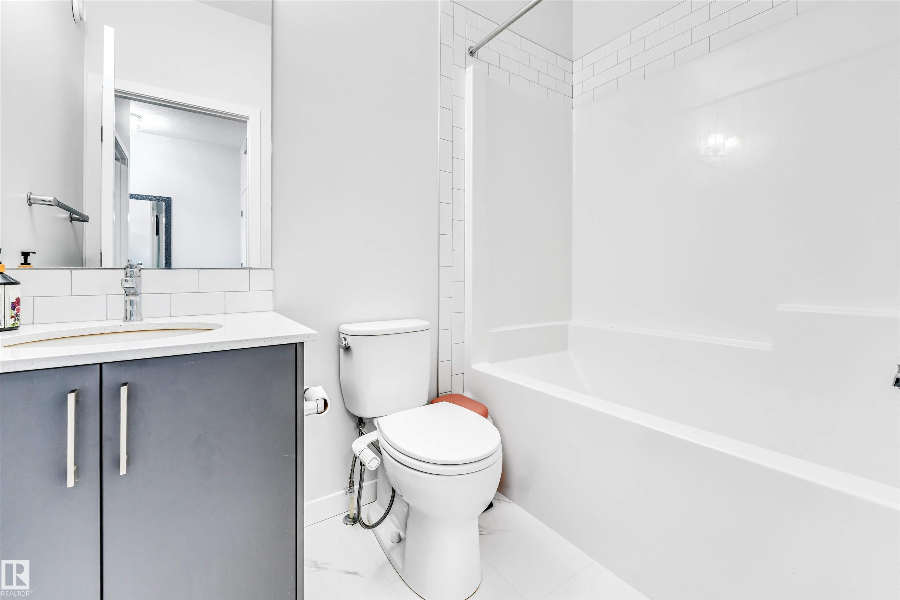Bathroom featuring a vanity with two-door storage, an undermount sink, and a mirrored medicine cabinet - 425 41 Street, Edmonton, AB - Indoor Photo Showing Bathroom