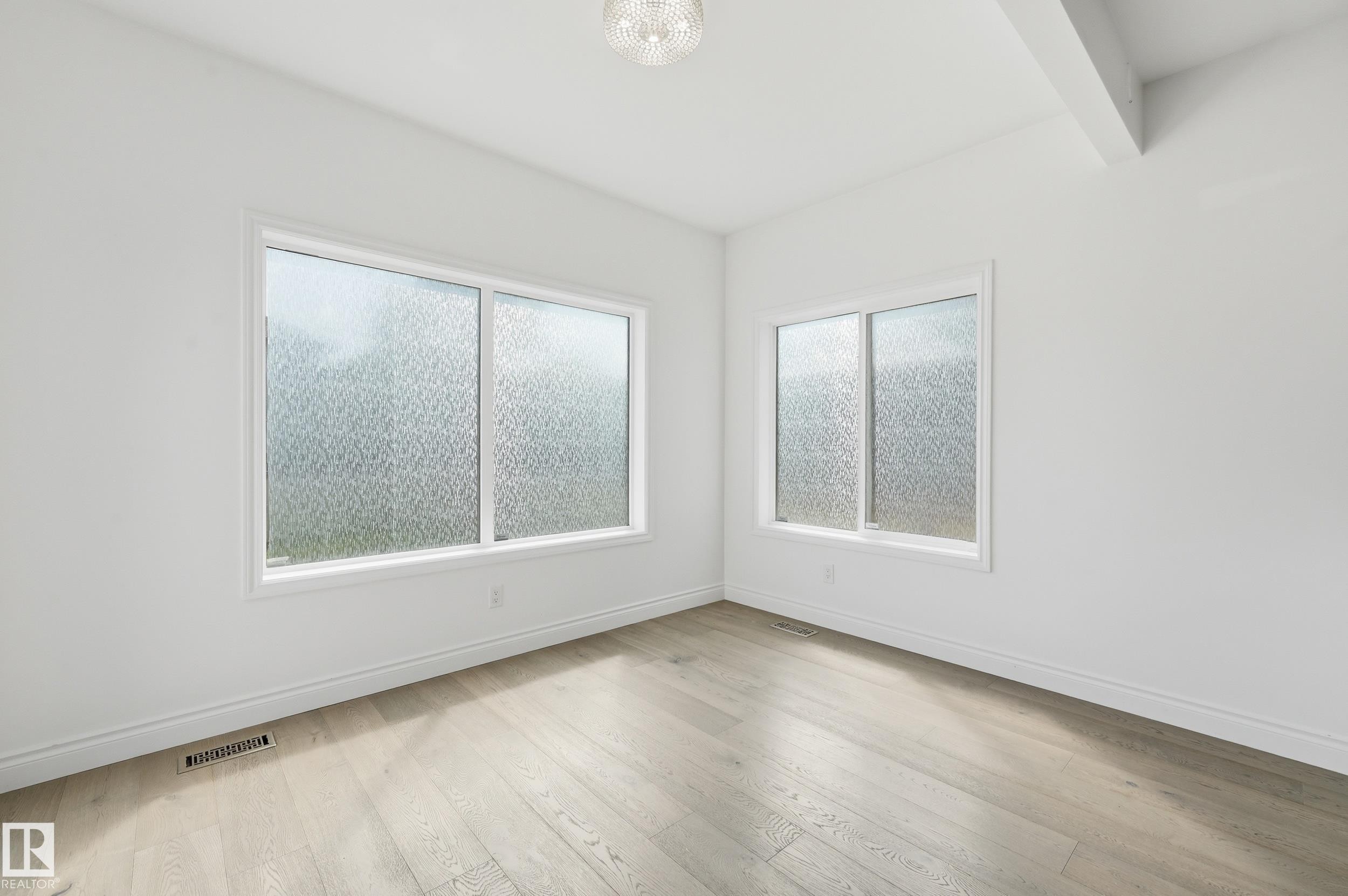Room featuring light wood-finish flooring, white baseboards, and white walls - 1 Southfork Close, Leduc, AB - Indoor Photo Showing Other Room