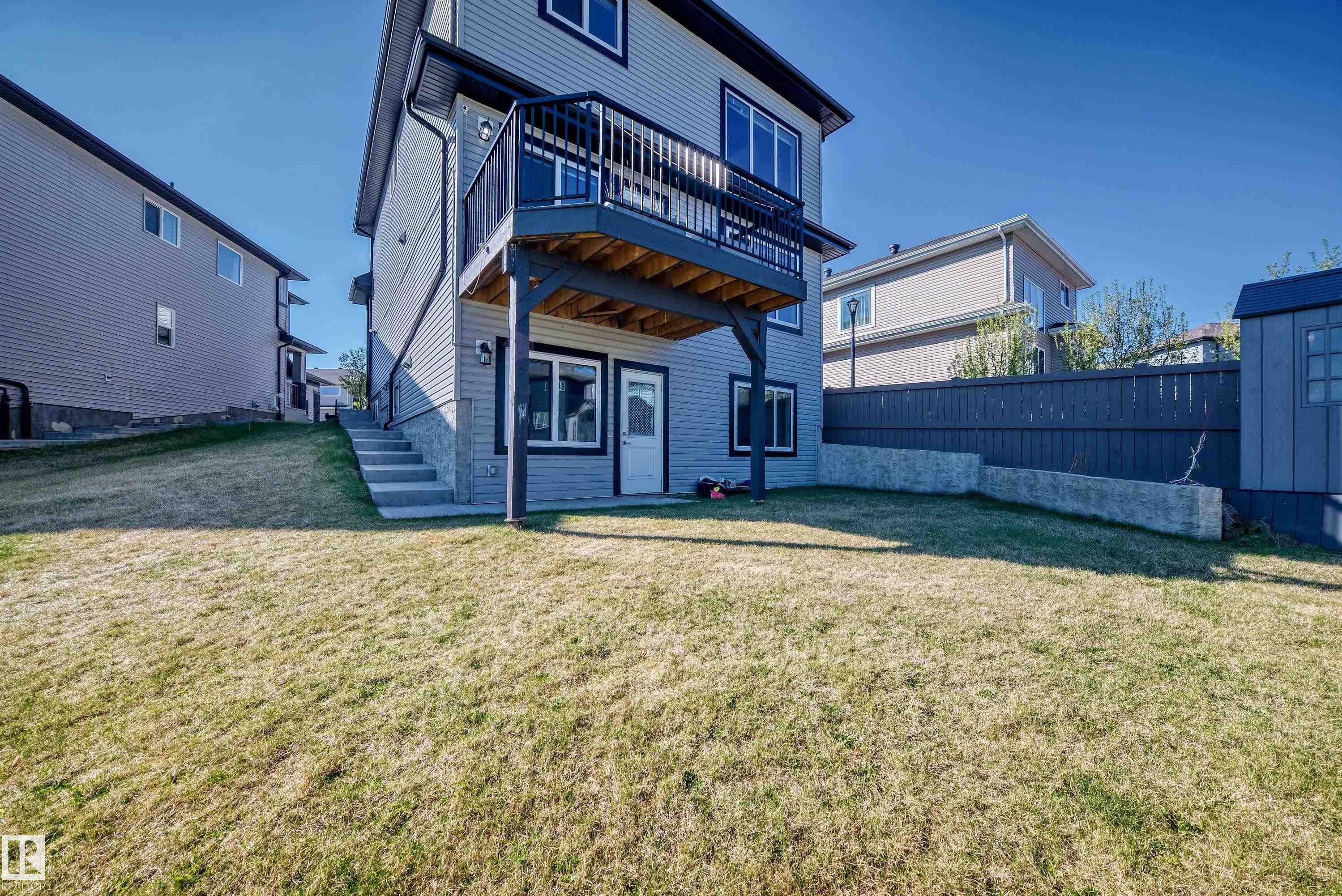 Rear exterior with light gray siding and dark trim - 2464 15 Avenue Nw, Edmonton, AB - Outdoor