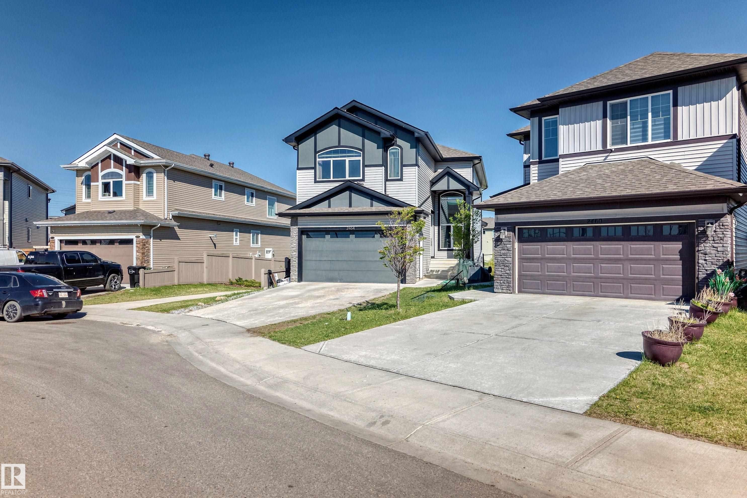 Two-story residence featuring a gray exterior with dark trim accents and an attached garage - 2464 15 Avenue Nw, Edmonton, AB - Outdoor With Facade