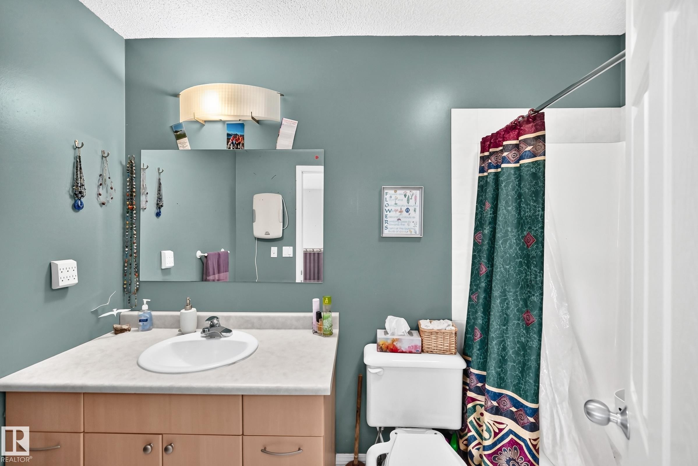 Bathroom featuring a vanity with a laminate countertop, an oval sink, and wood-finish cabinetry - 1116 39 Street Nw, Edmonton, AB - Indoor Photo Showing Bathroom