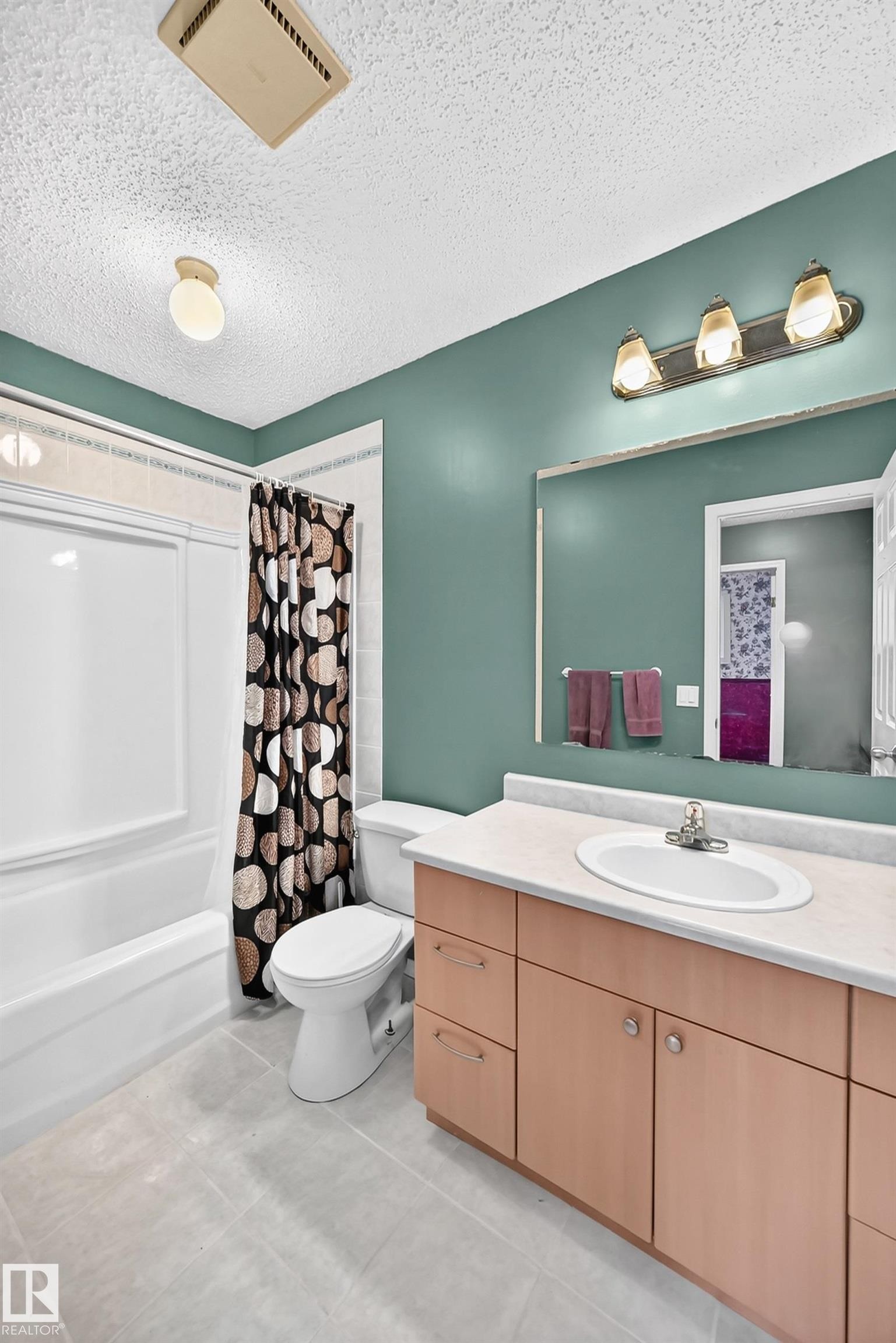 Bathroom featuring a single vanity with a laminate countertop, integrated sink, and chrome faucet - 1116 39 Street Nw, Edmonton, AB - Indoor Photo Showing Bathroom