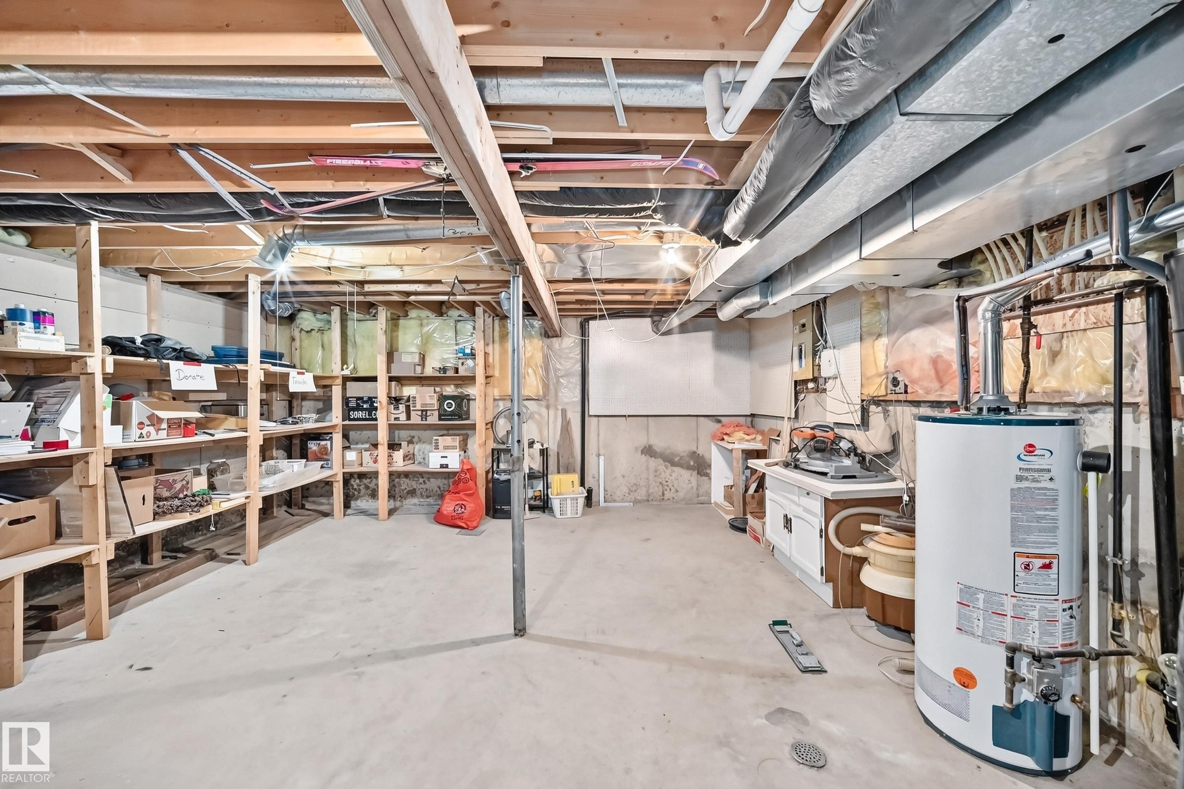 Unfinished basement featuring exposed ceiling joists and concrete flooring - 1116 39 Street Nw, Edmonton, AB - Indoor Photo Showing Basement