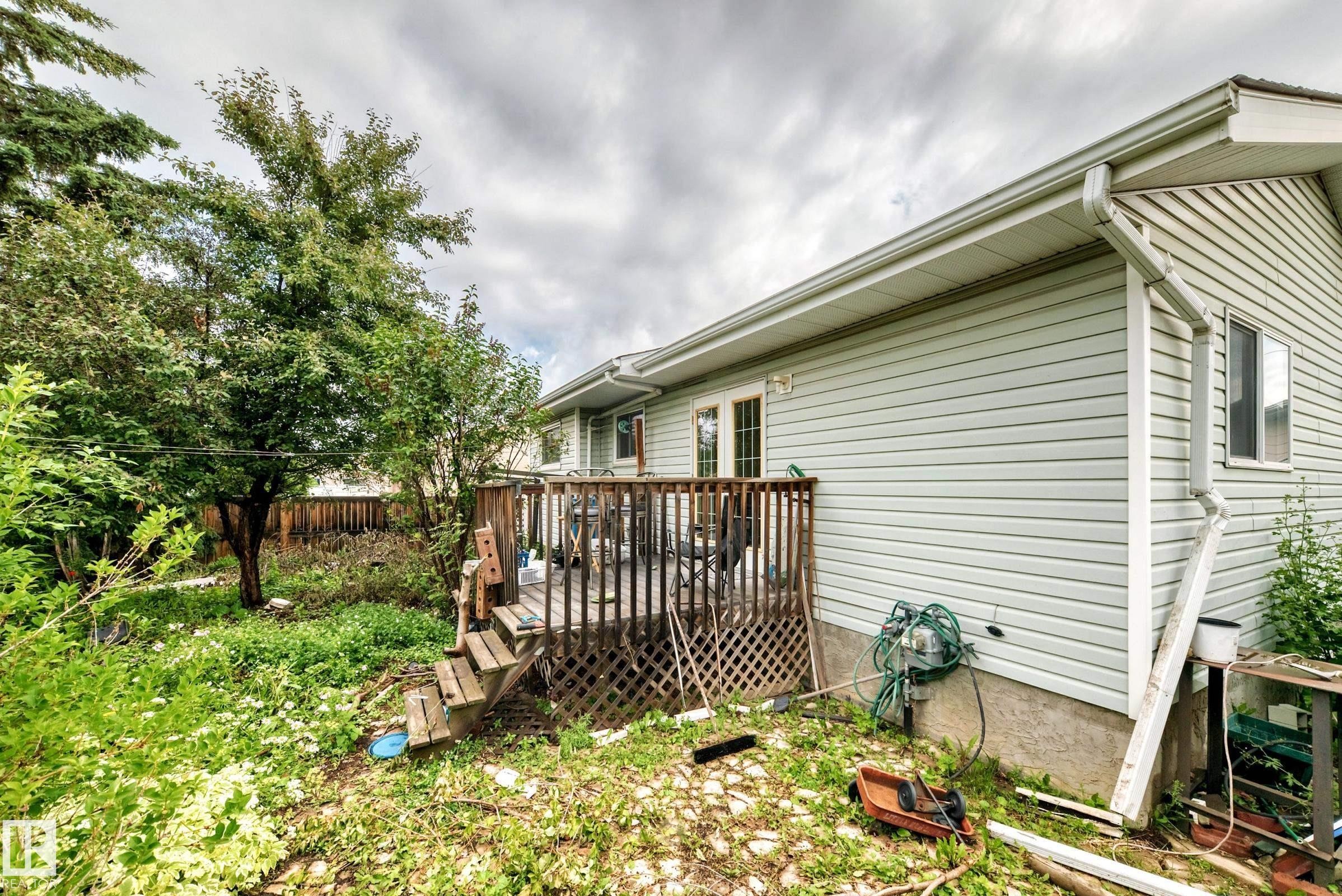 Rear exterior with light green vinyl siding and white trim - 1116 39 Street Nw, Edmonton, AB - Outdoor
