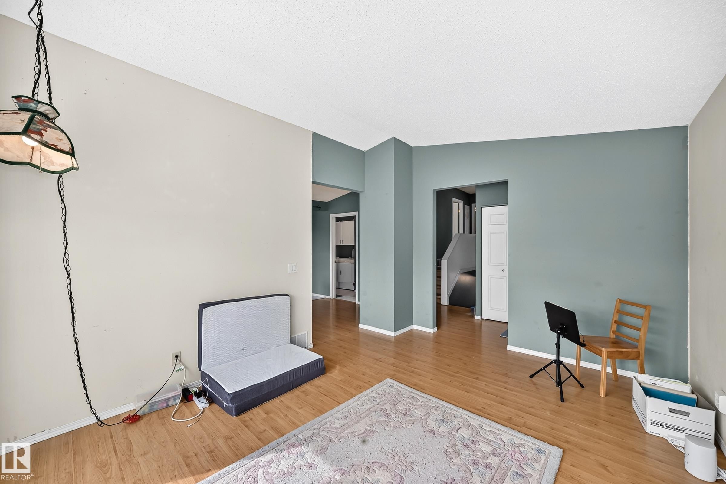 Bright interior space featuring wood-finish flooring, two-tone wall paint, and white trim molding - 1116 39 Street Nw, Edmonton, AB - Indoor