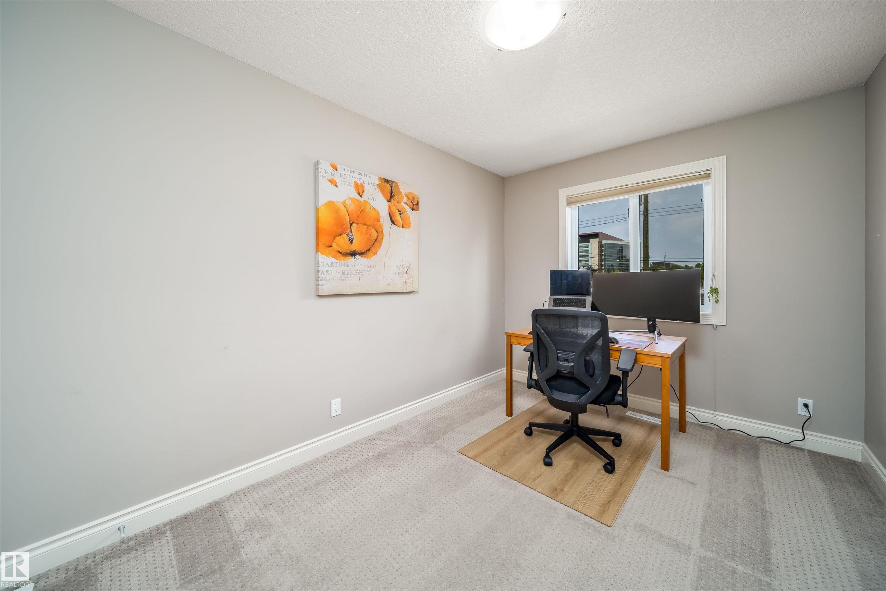 Light-filled room featuring neutral wall paint, white trim, and a window providing natural illumination - 11342 79 Avenue, Edmonton, AB - Indoor Photo Showing Other Room