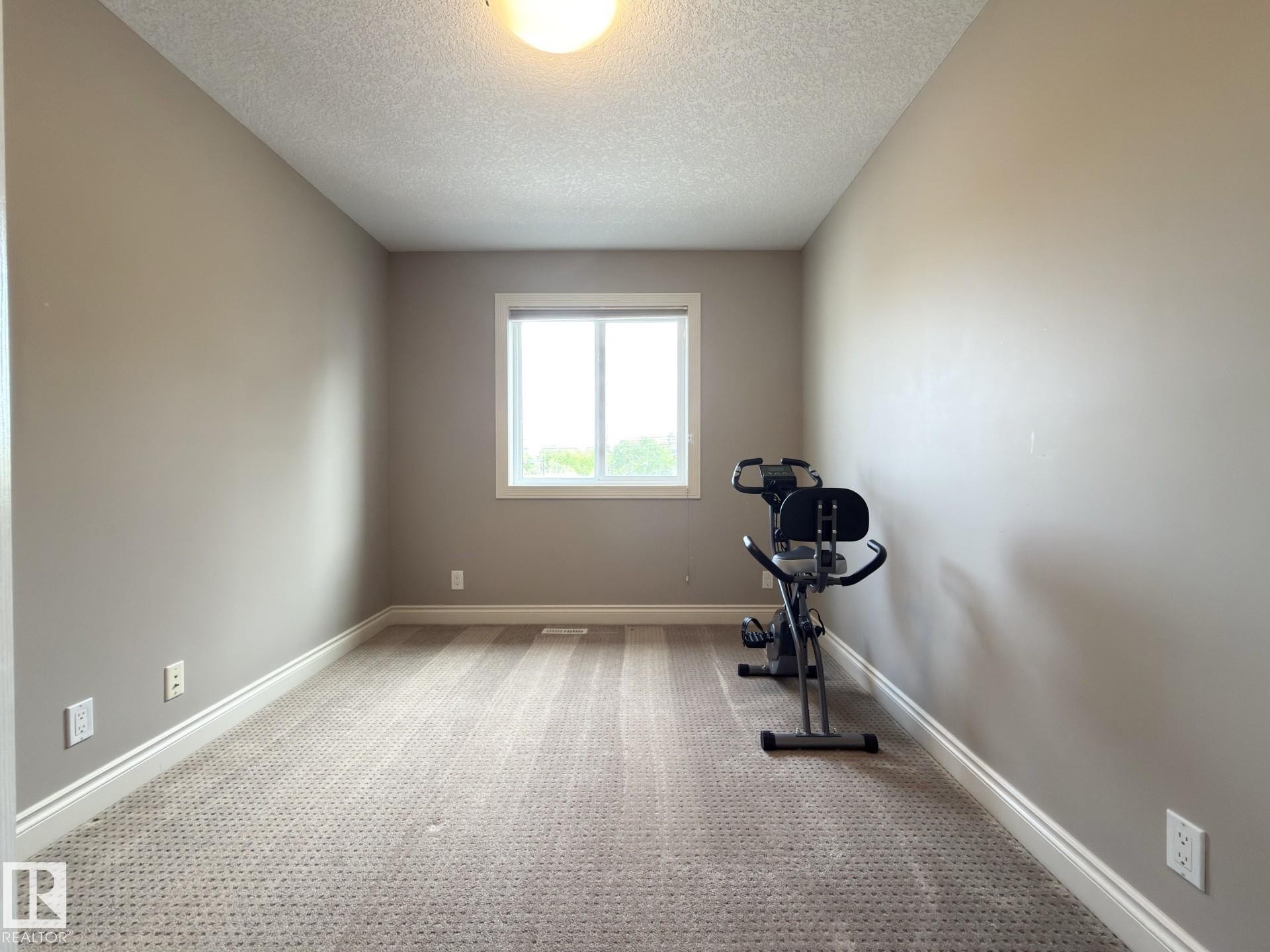 Neutral-toned walls complement the textured carpet flooring and white trim - 11342 79 Avenue, Edmonton, AB - Indoor