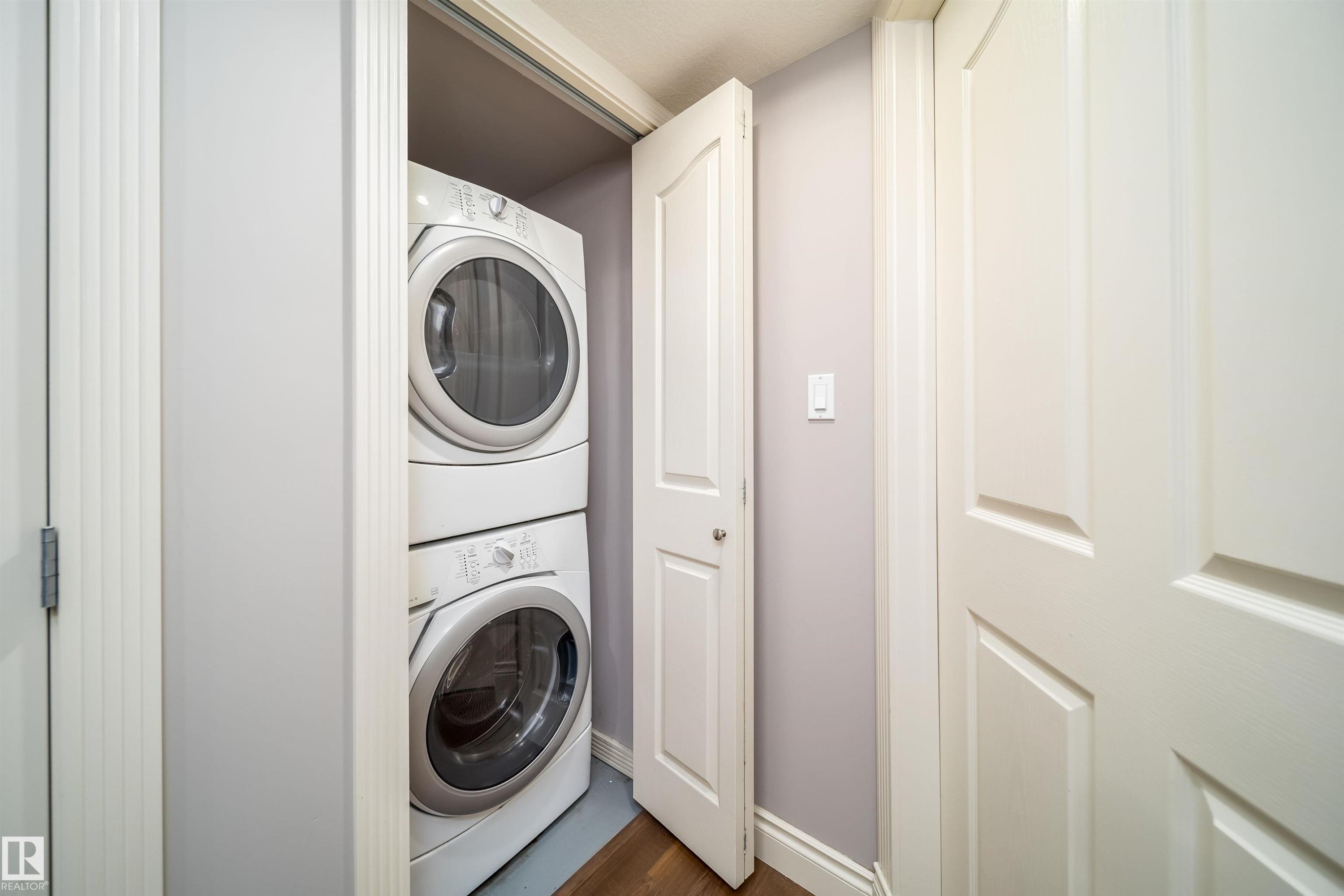 Dedicated laundry closet featuring a stacked washer and dryer unit - 11342 79 Avenue, Edmonton, AB - Indoor Photo Showing Laundry Room