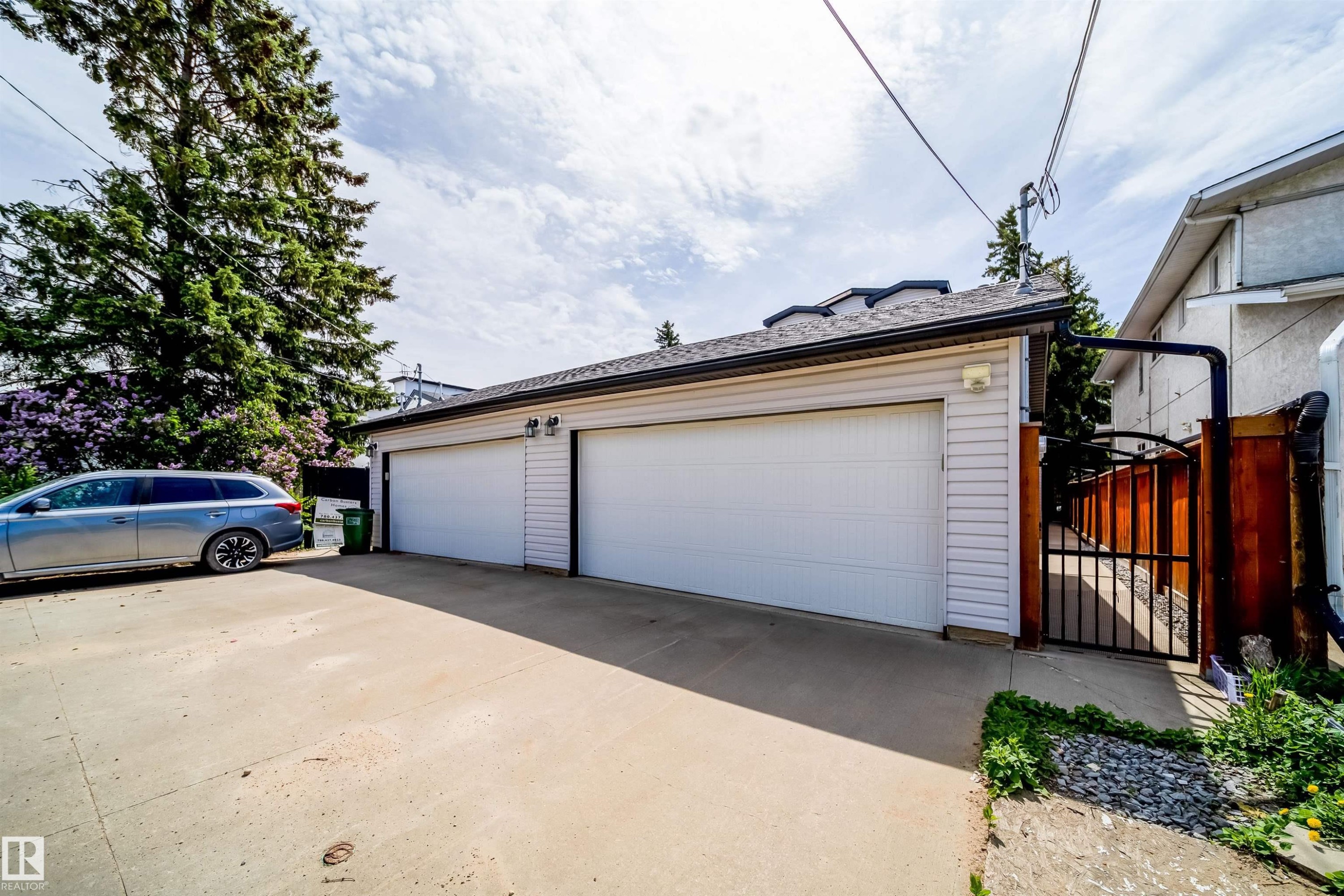 Detached two-car garage with white paneled doors and light-colored siding - 11342 79 Avenue, Edmonton, AB - Outdoor With Exterior