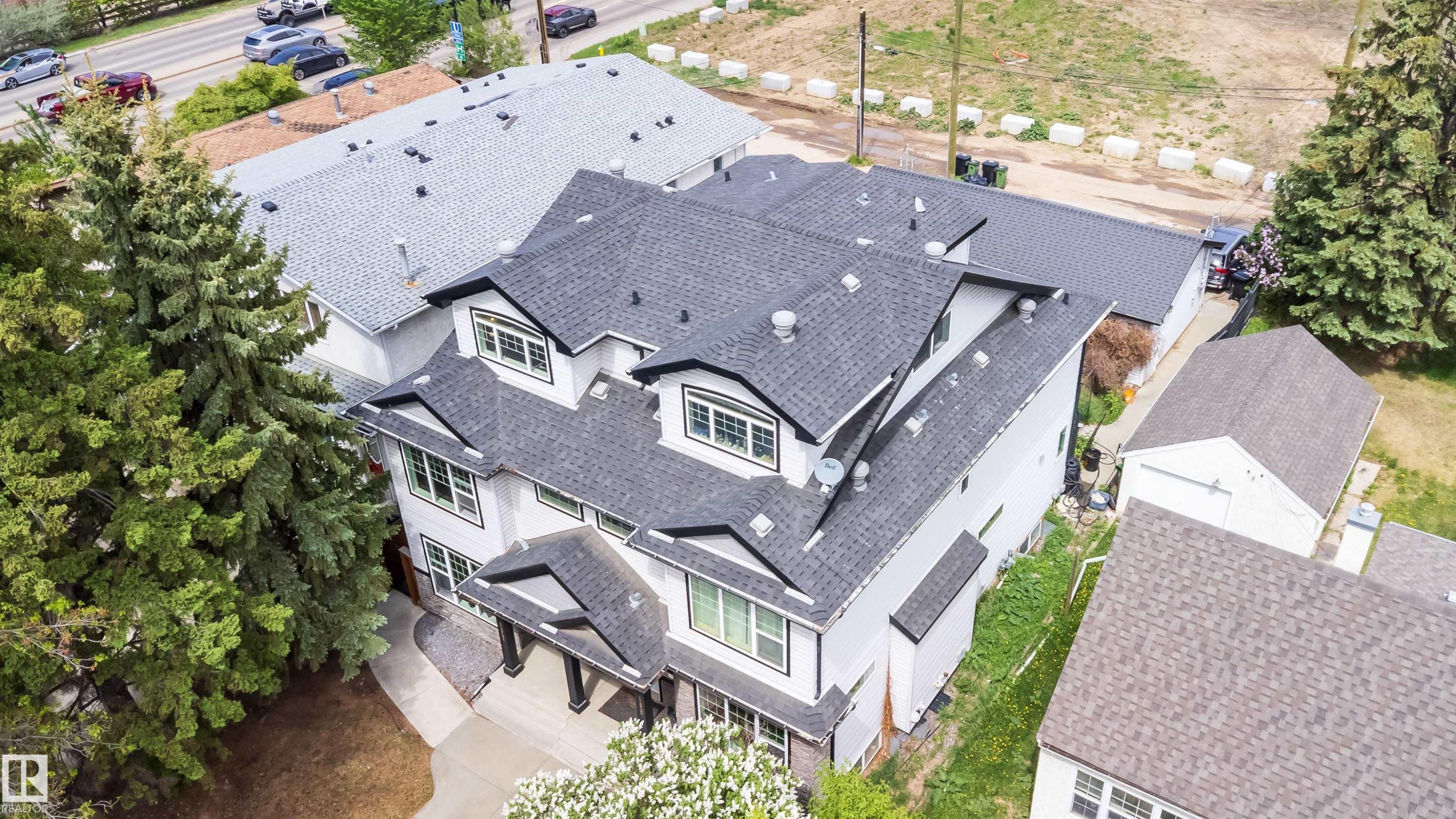 Two-story residence featuring a dark shingle roof, white siding, and black trim windows - 11342 79 Avenue, Edmonton, AB - Outdoor