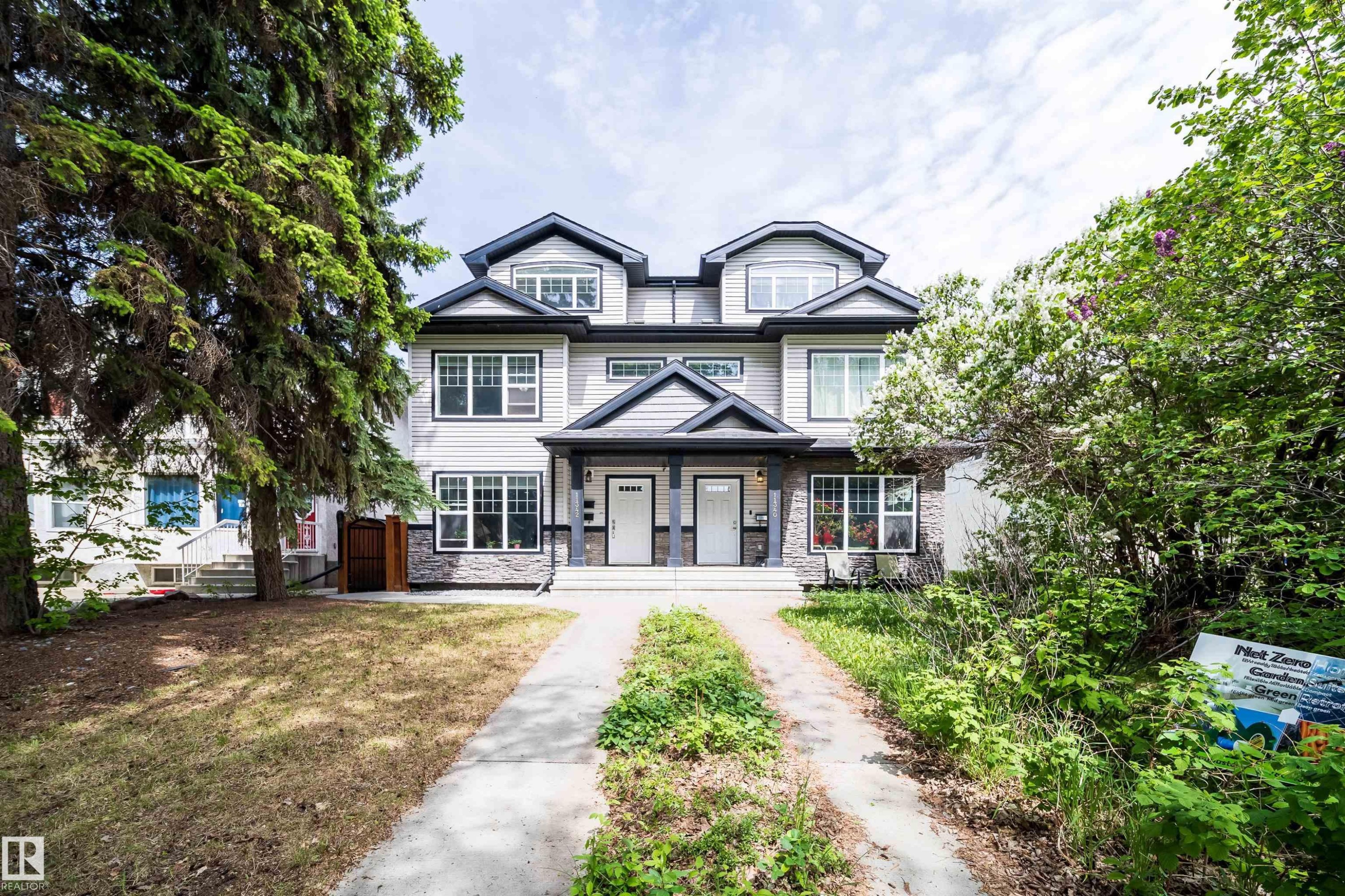 Contemporary duplex with light-colored siding and dark trim accents - 11342 79 Avenue, Edmonton, AB - Outdoor With Facade