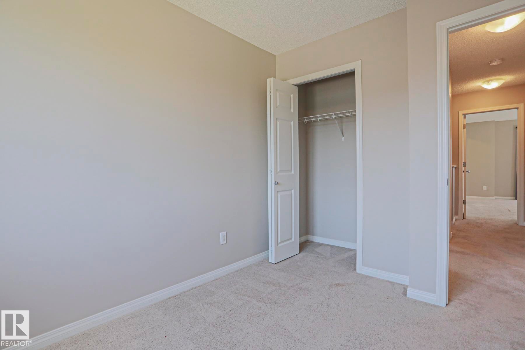 Neutral-toned walls complement plush carpeting throughout this space - 489 Orchards Boulevard Sw, Edmonton, AB - Indoor Photo Showing Other Room