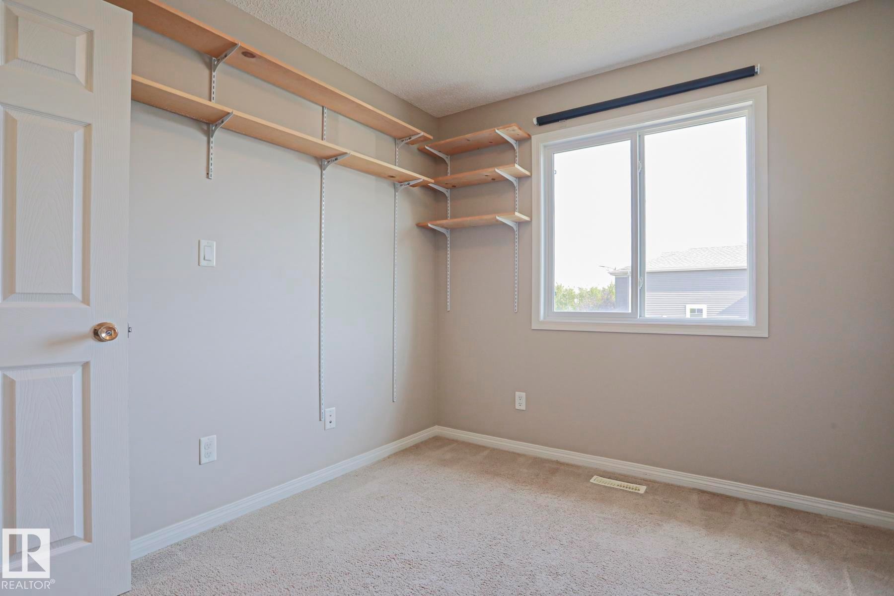 Room featuring neutral wall paint, light-colored carpeting, and white trim - 489 Orchards Boulevard Sw, Edmonton, AB - Indoor Photo Showing Other Room