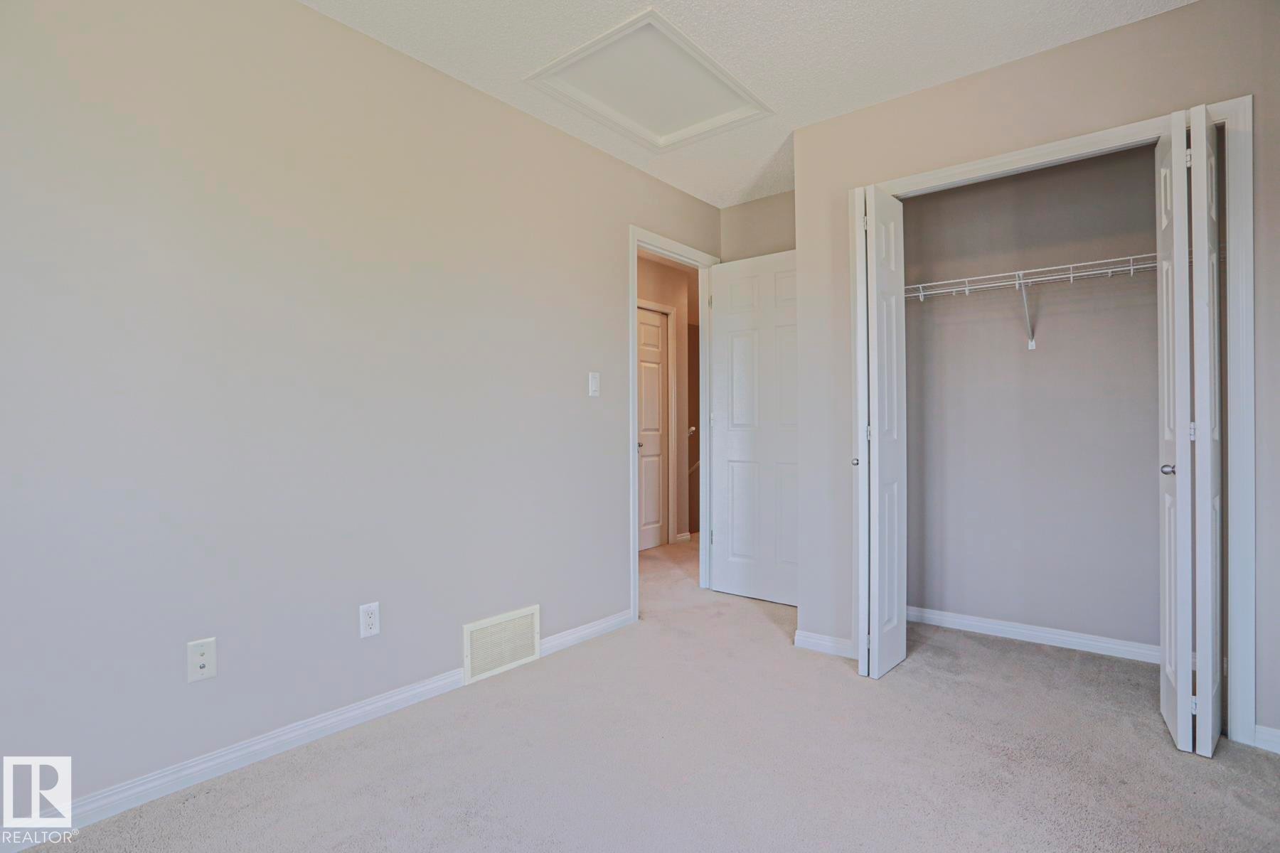 Soft neutral wall color throughout, offering a versatile aesthetic - 489 Orchards Boulevard Sw, Edmonton, AB - Indoor Photo Showing Other Room