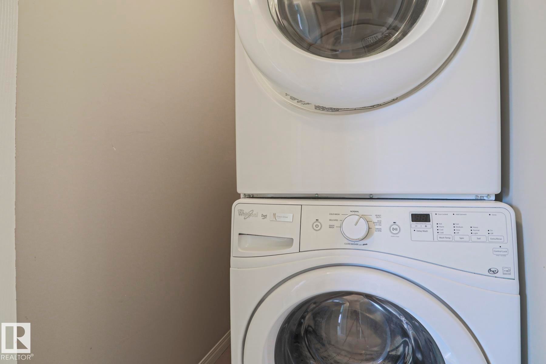 Stackable washer and dryer unit - 489 Orchards Boulevard Sw, Edmonton, AB - Indoor Photo Showing Laundry Room