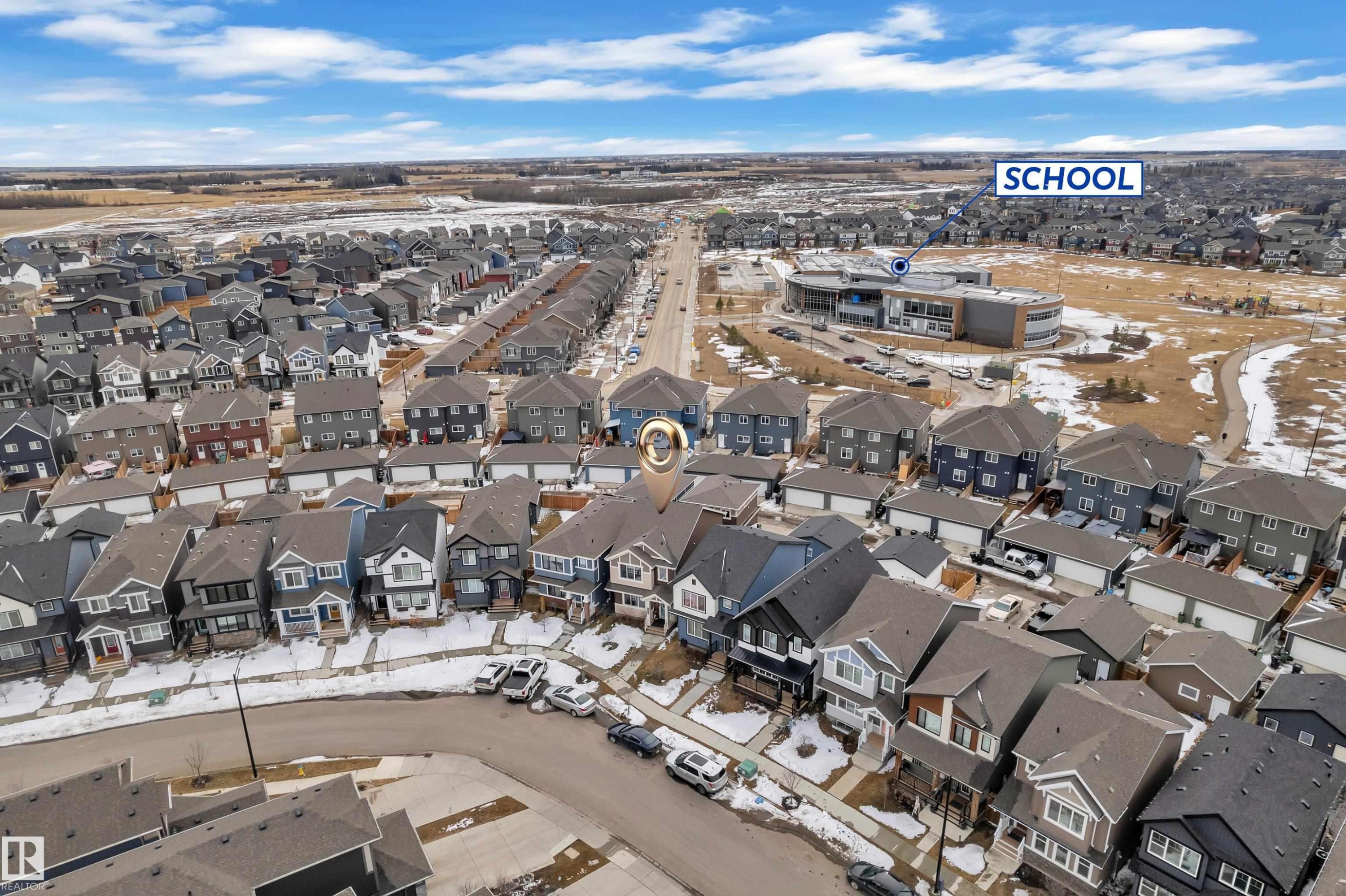 Aerial perspective of a residential community featuring single-family homes with attached garages - 1645 Plum Circle Circle Sw, Edmonton, AB - Outdoor With View