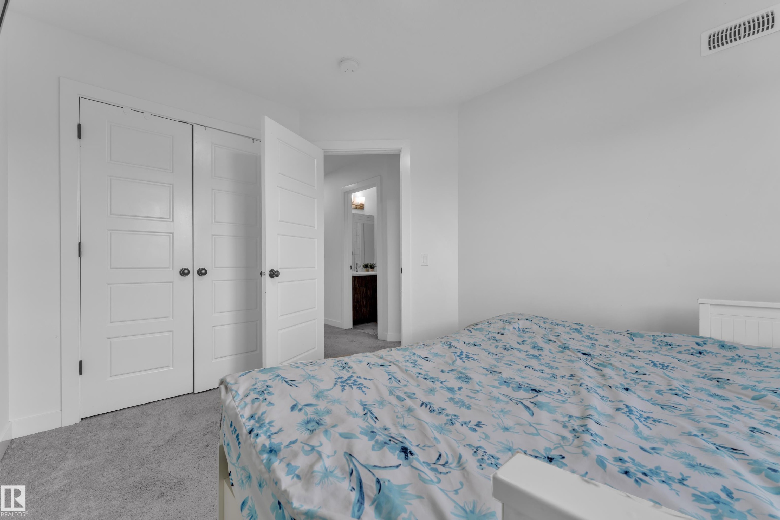 Bedroom featuring light gray carpeting, crisp white walls, and a recessed ceiling light - 1645 Plum Circle Circle Sw, Edmonton, AB - Indoor Photo Showing Bedroom
