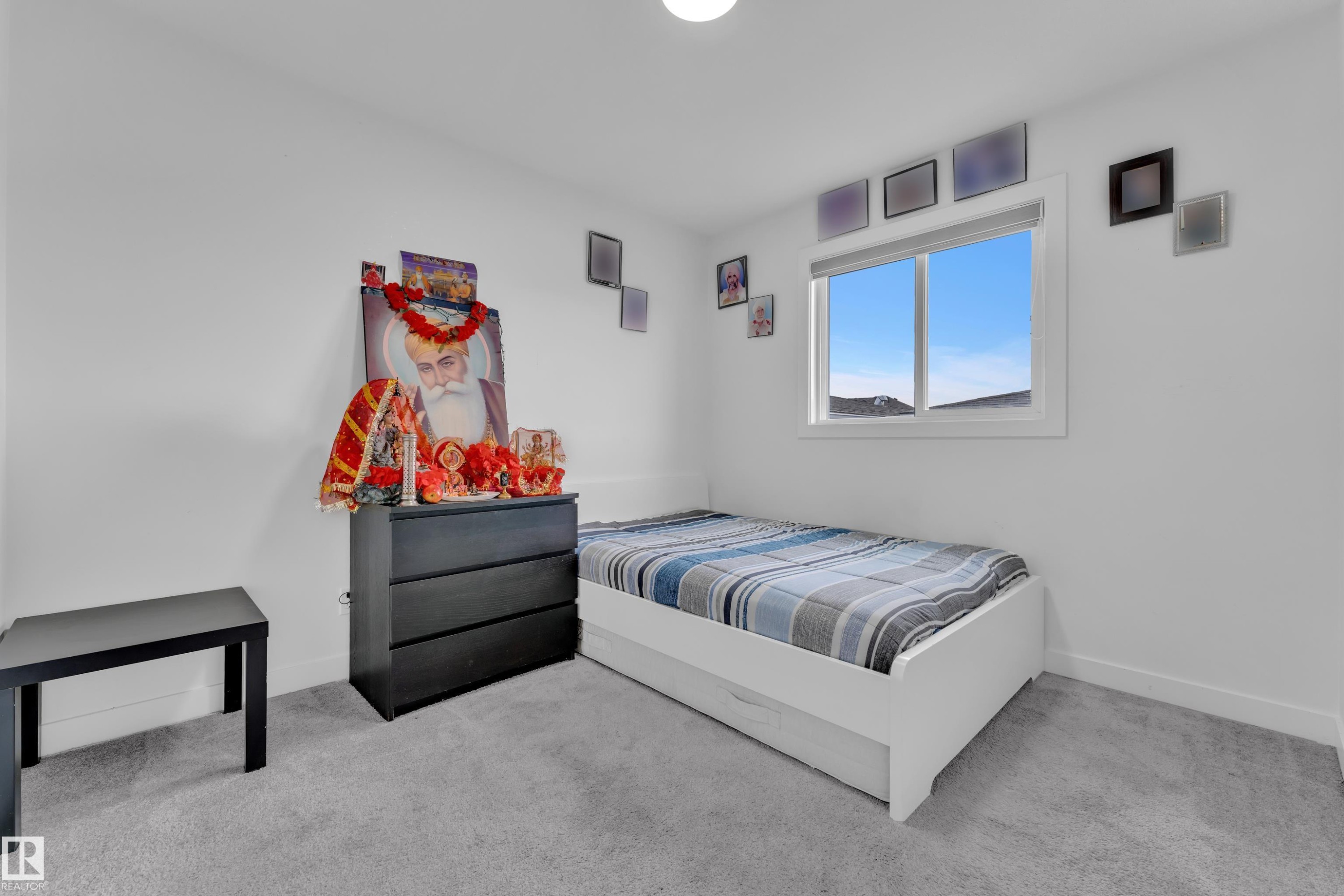 Bright room featuring soft gray carpet flooring, white walls, and a large window with white trim - 1645 Plum Circle Circle Sw, Edmonton, AB - Indoor Photo Showing Bedroom