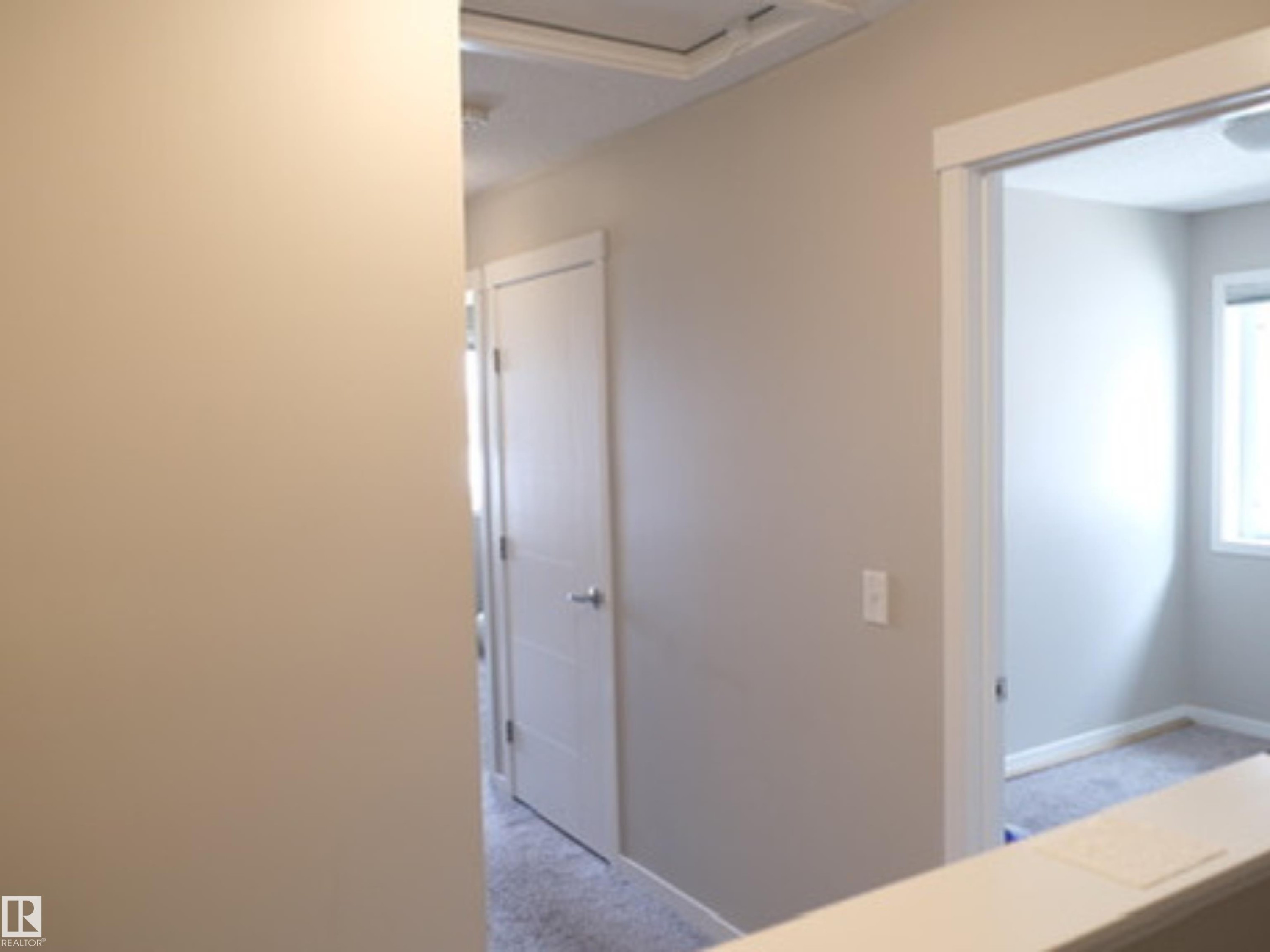 Interior hallway with neutral tone walls and white trim - 17263 9 Avenue Sw, Edmonton, AB